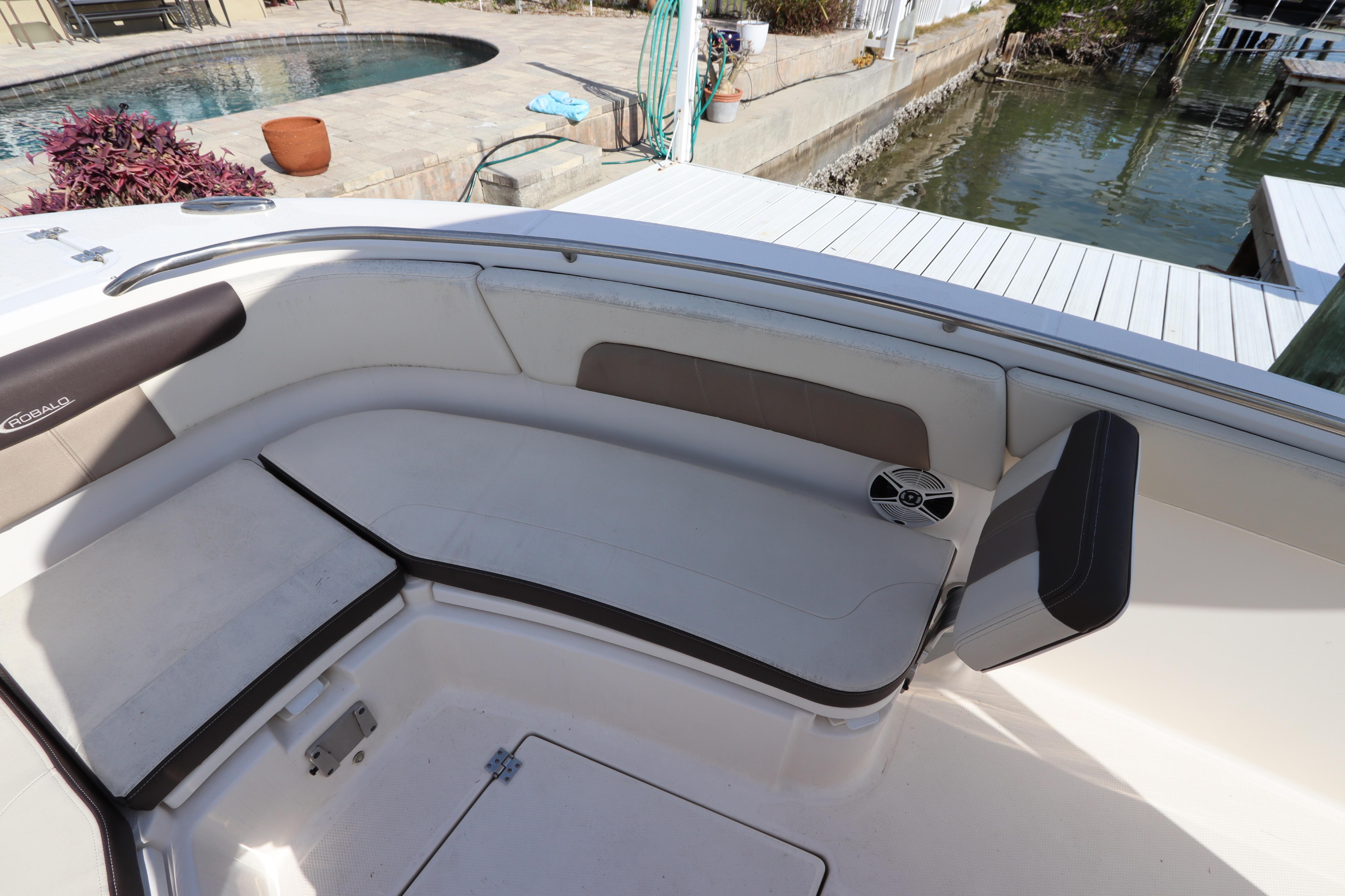 2019 Robalo R242 Center Console boat interior with cushioned seating by the dock.