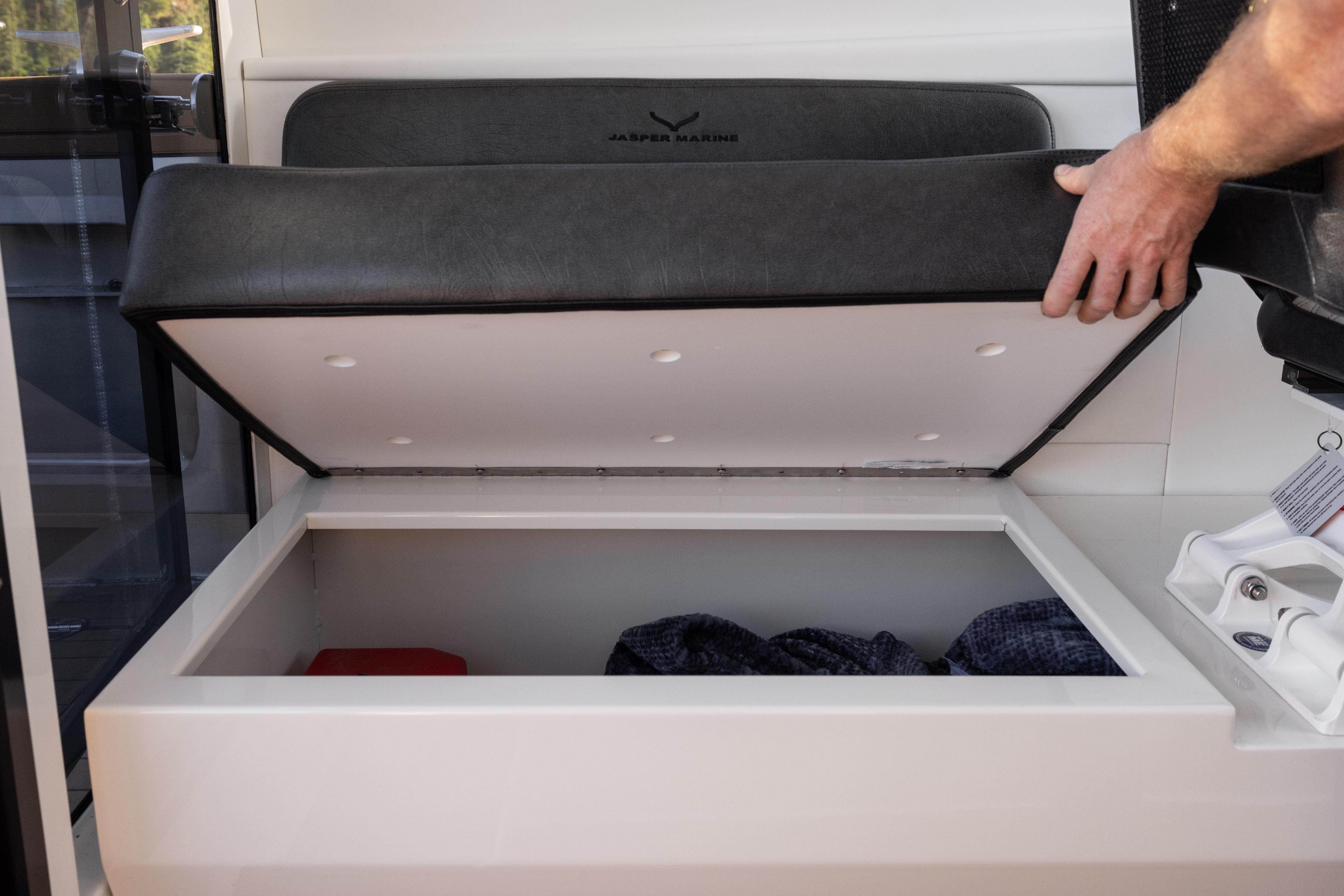 Open storage compartment on Jasper Marine Defender 22 boat, 2026 model.