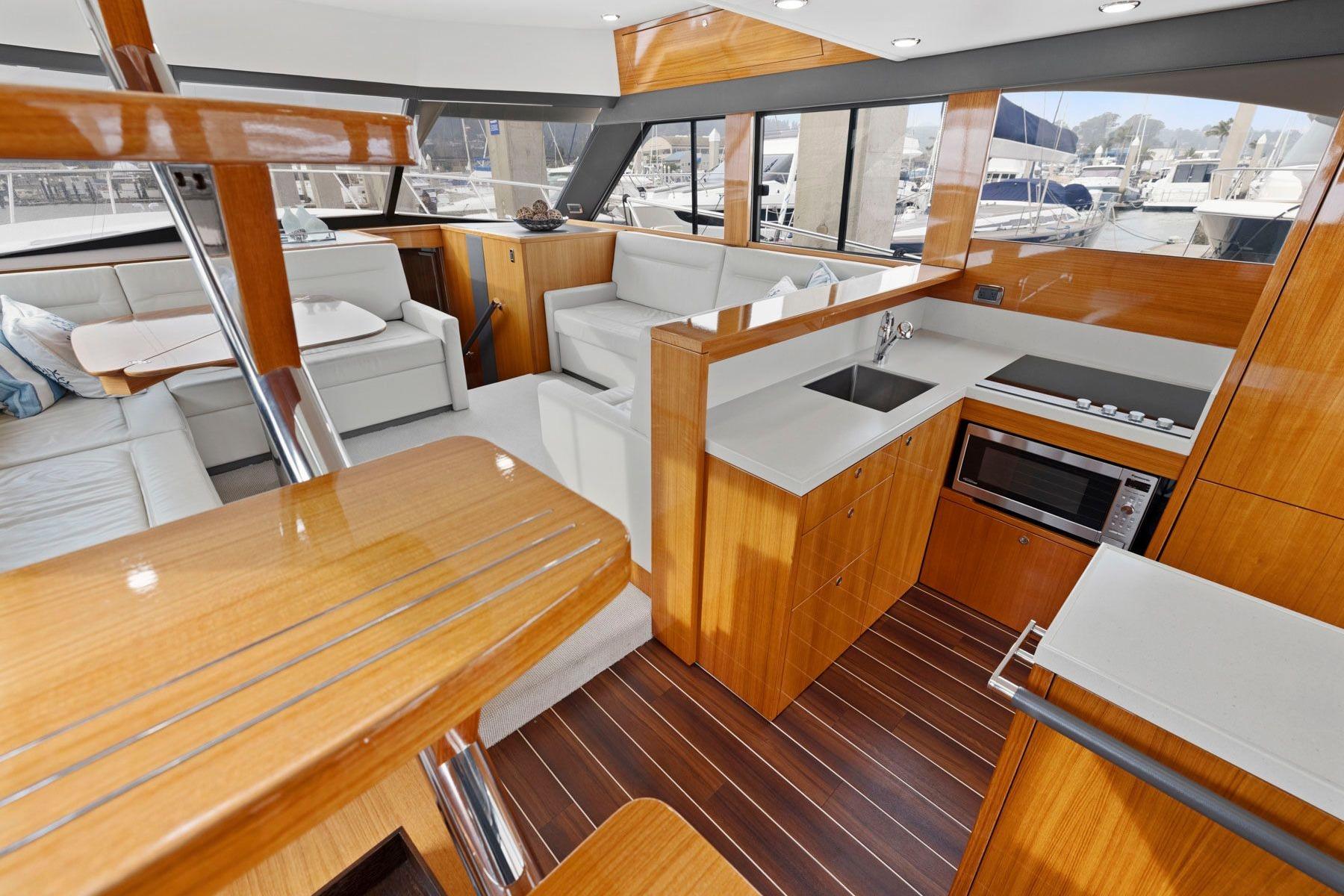 Luxurious interior of 2014 Maritimo M50 yacht with modern kitchen and seating area.