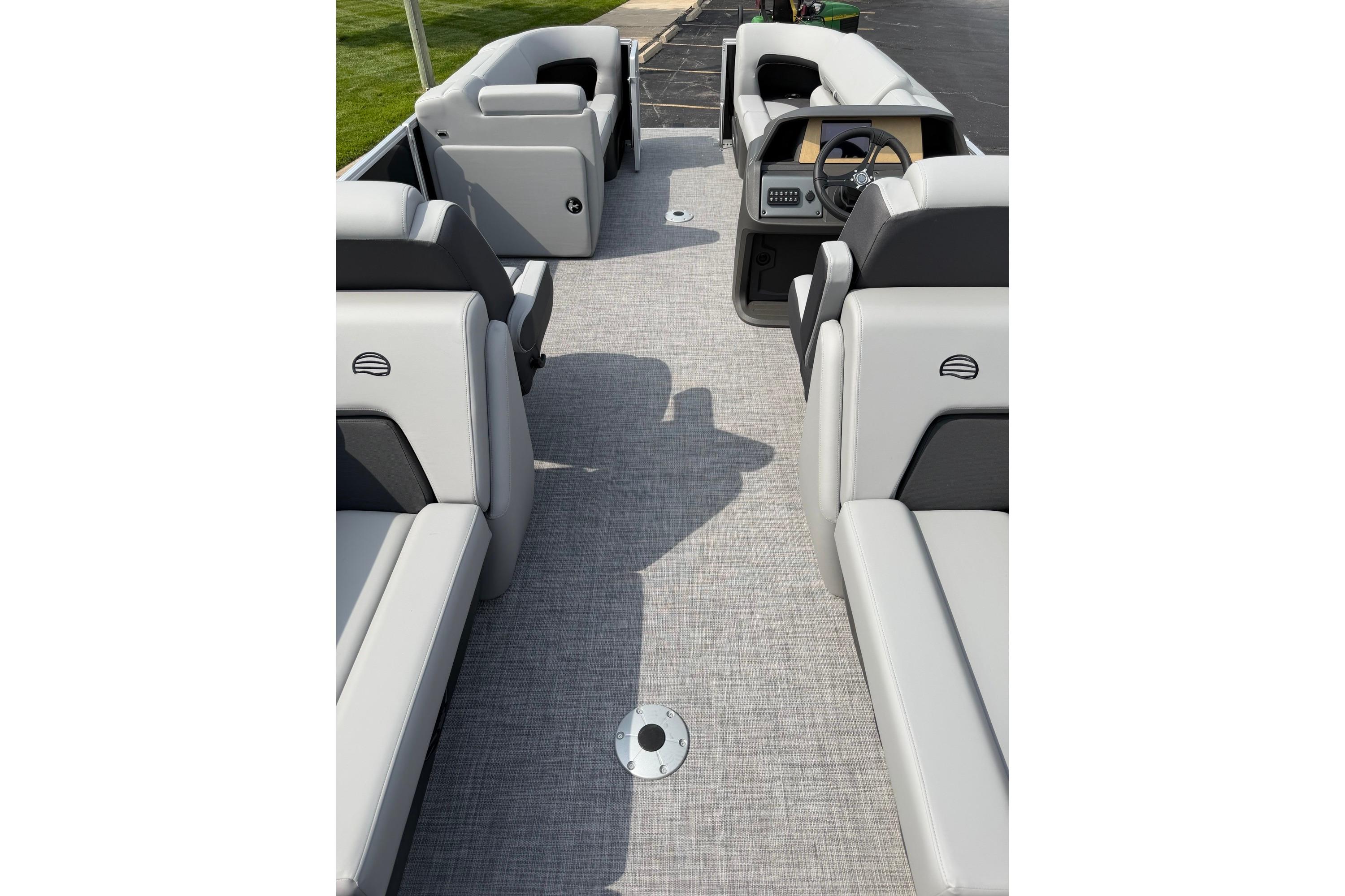 2026 Sun Tracker Party Barge 22 DLX interior with plush seating and modern dashboard.