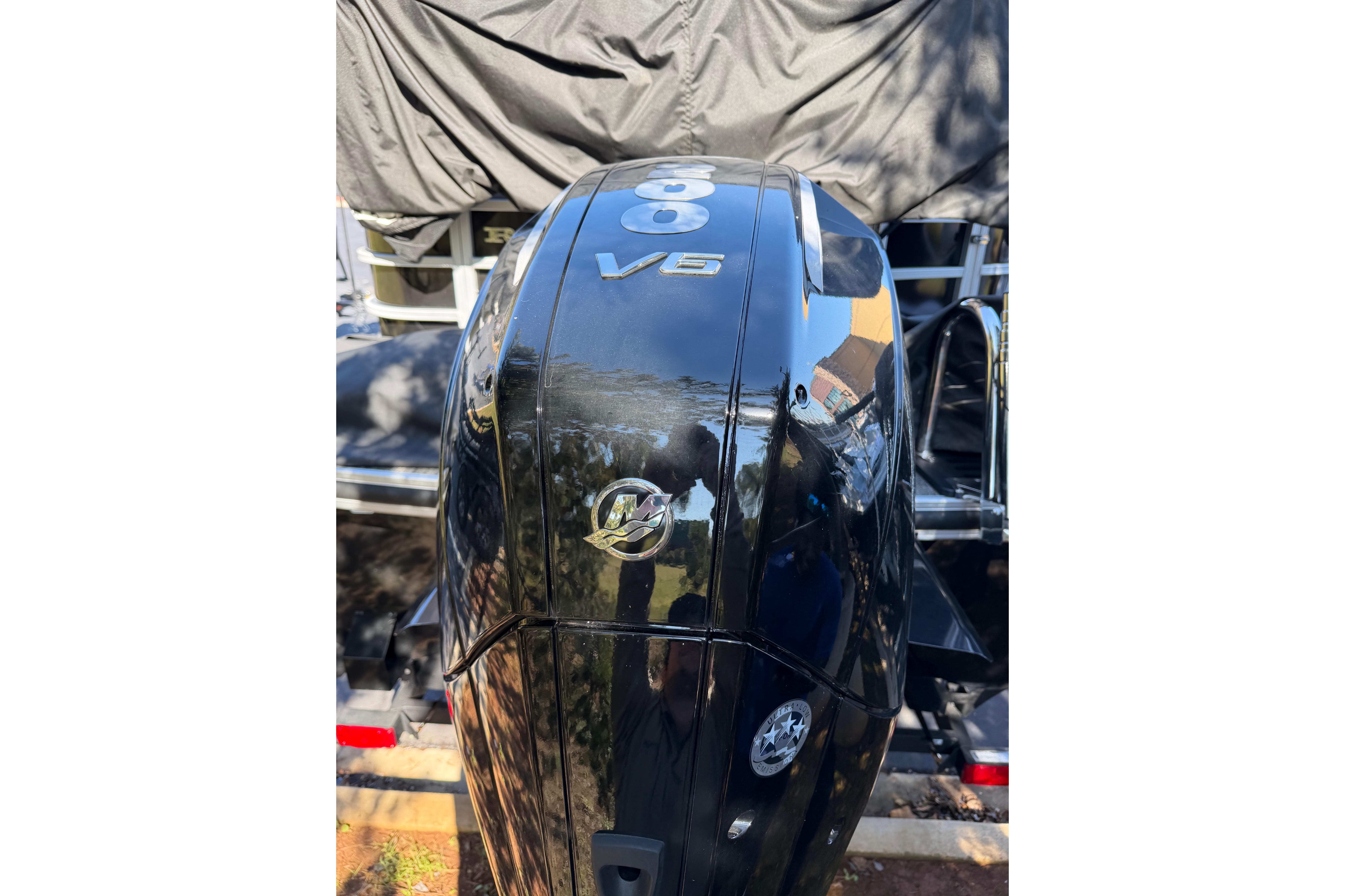2024 Ranger Reata 223C boat with a powerful V6 engine, black exterior.