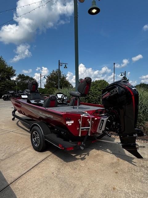 2025 Ranger RT188P boat with powerful outboard motor, parked on a sunny day.