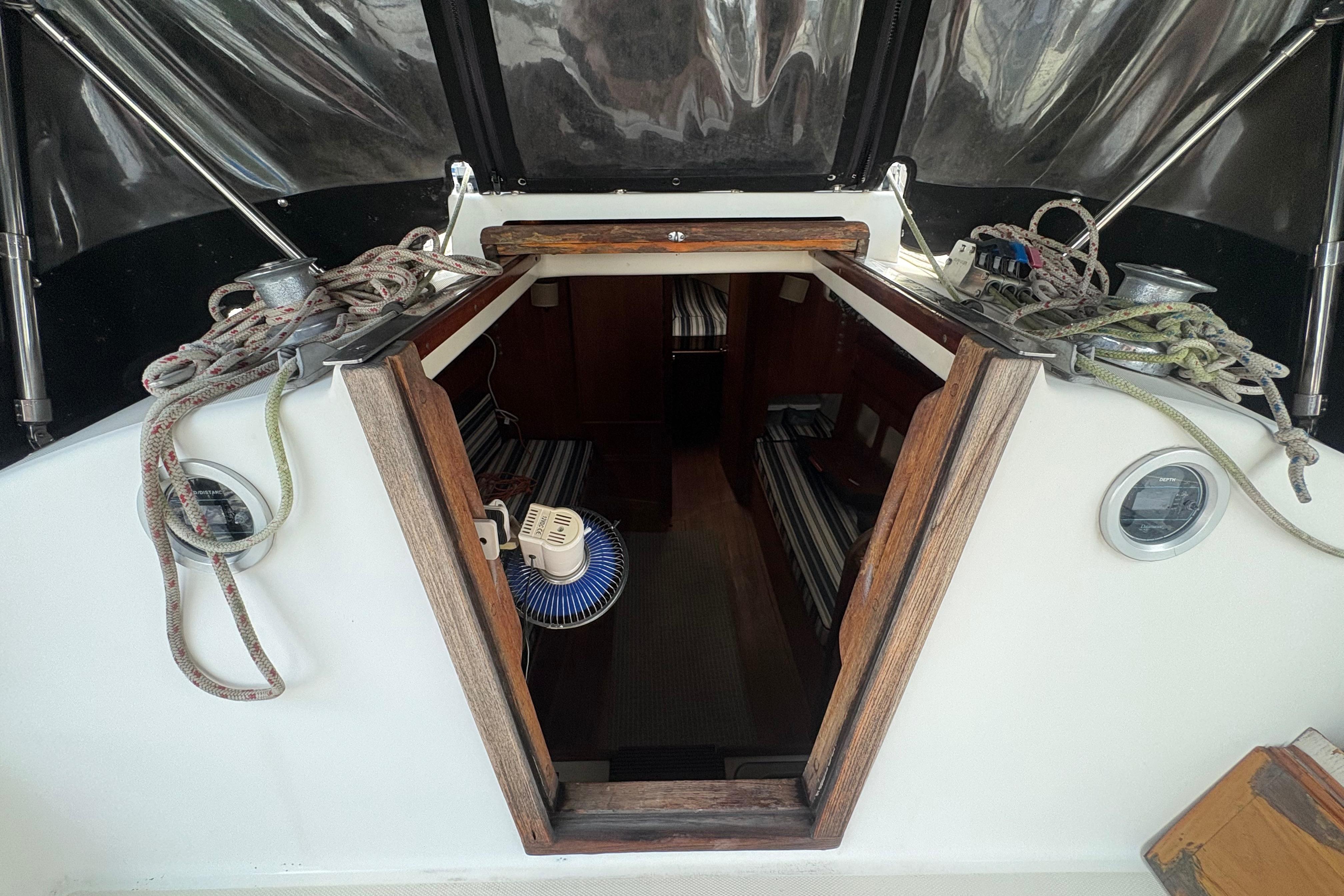 Interior view of a 1981 Sabre 31 sailboat cabin entrance with ropes and winches.