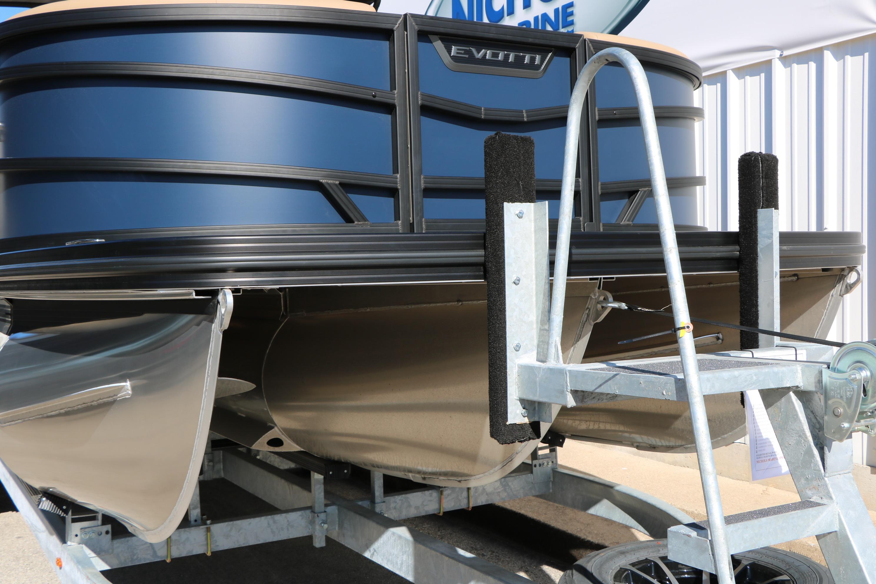 2026 Evotti 525 QL Tri-Toon boat on trailer, showcasing sleek design and sturdy construction.