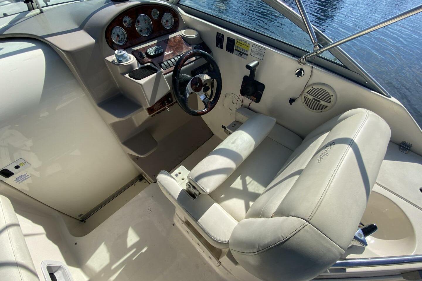 2005 Rinker Fiesta Vee 250 boat cockpit with steering wheel and control panel.