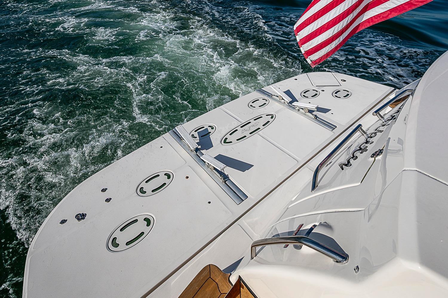 2008 Sea Ray 60 Sundancer yacht stern with American flag, cruising on open water.