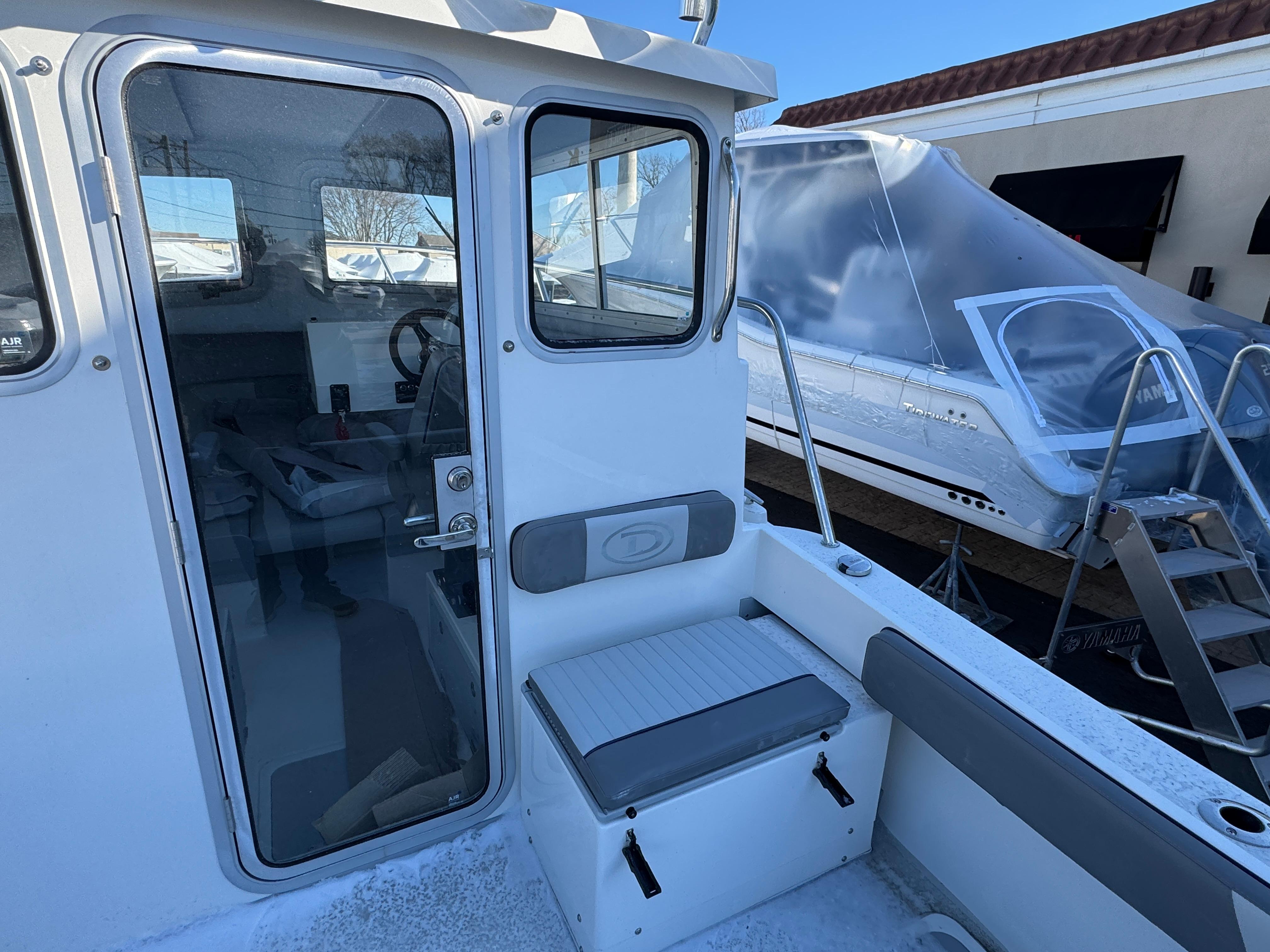 2025 Defiance Admiral 220 EX boat interior with seating and window view.