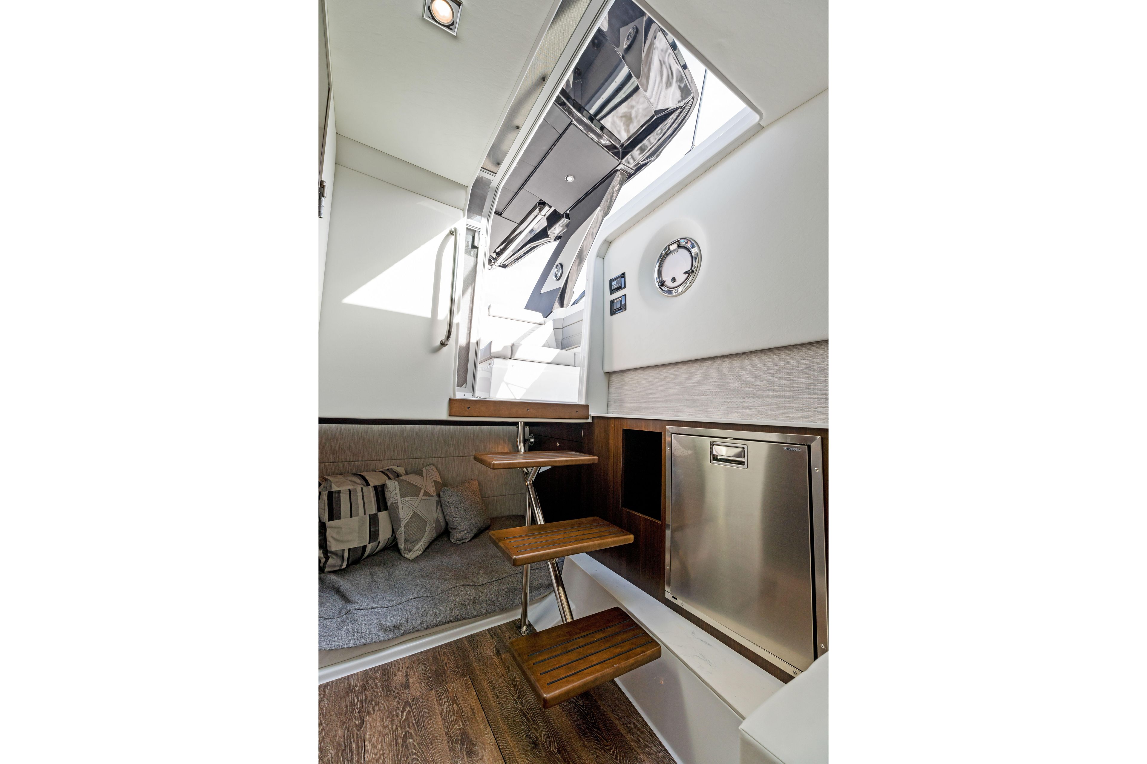 Interior of 2026 Cruisers Yachts 34 GLS OB, featuring stairs, seating, and modern design.