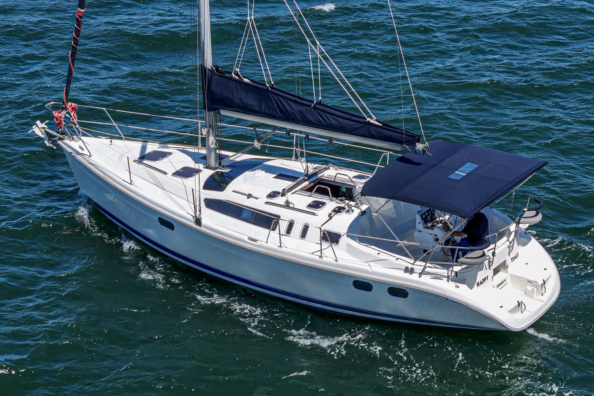 Sailing yacht Hunter 376, 1996 model, cruising on open water with blue sails.