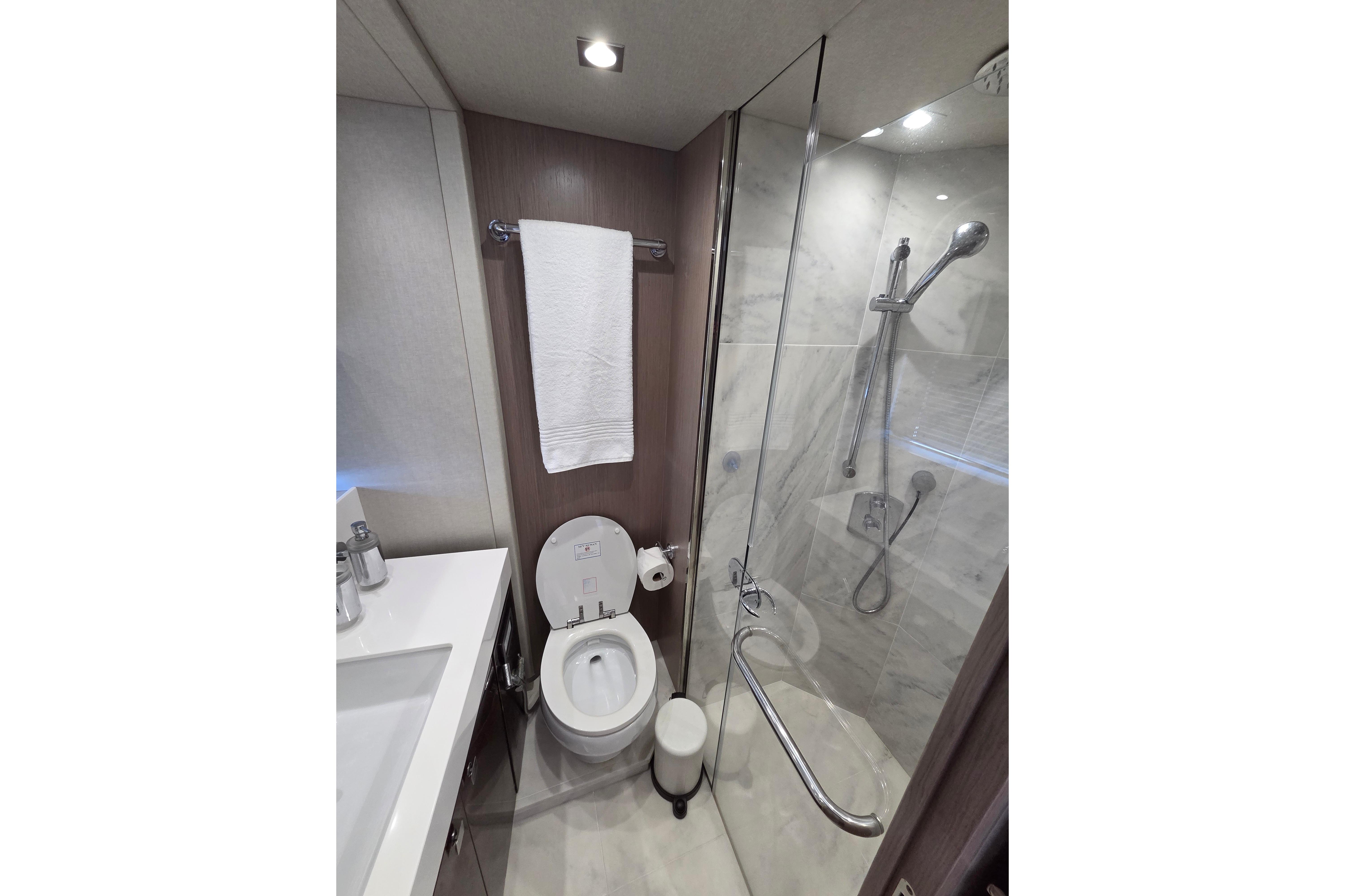Luxurious bathroom in 2018 Sunseeker 76 Yacht with modern fixtures and glass shower.