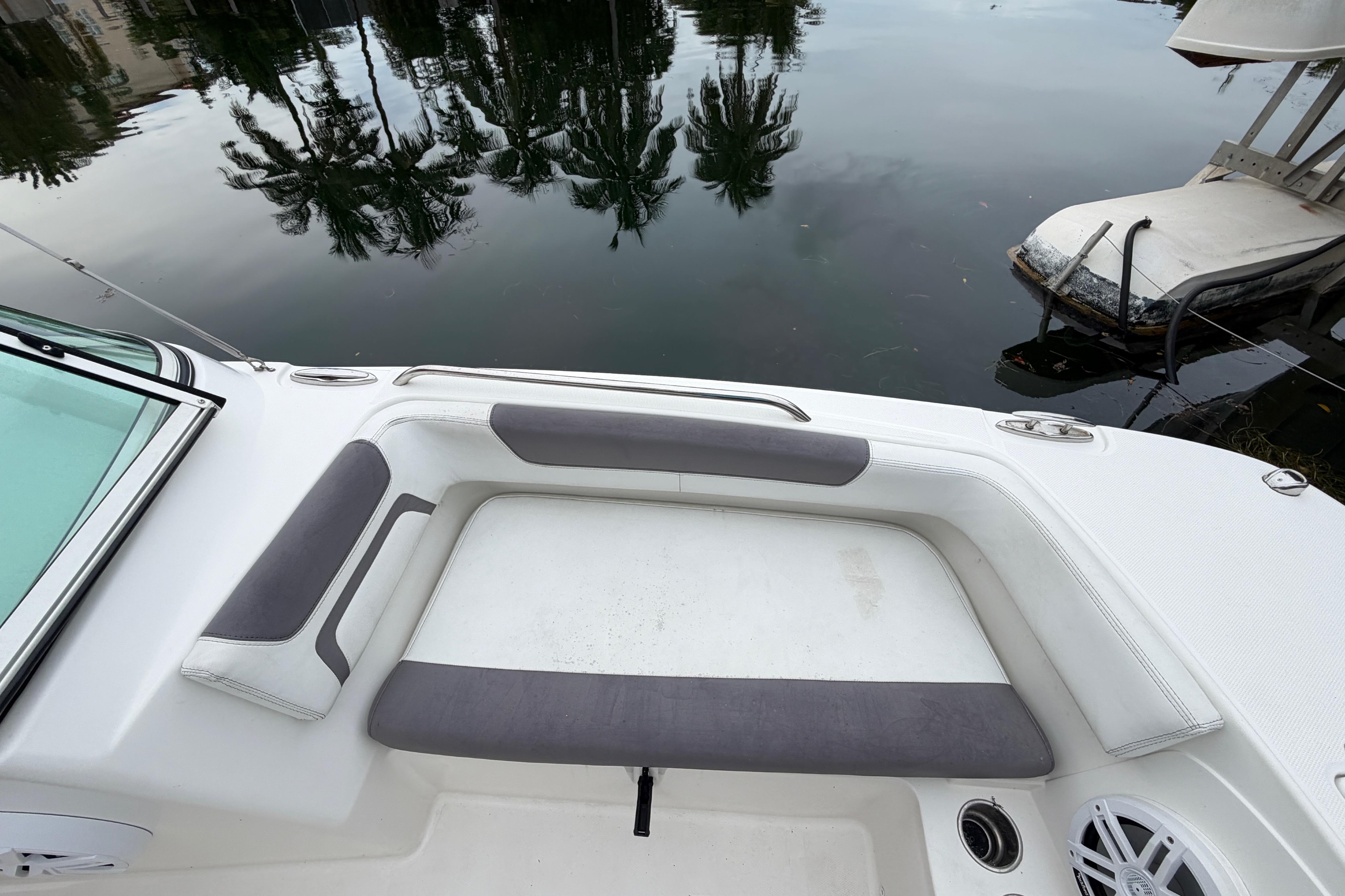 2019 World Cat 230 DC boat interior with cushioned seating by calm water.