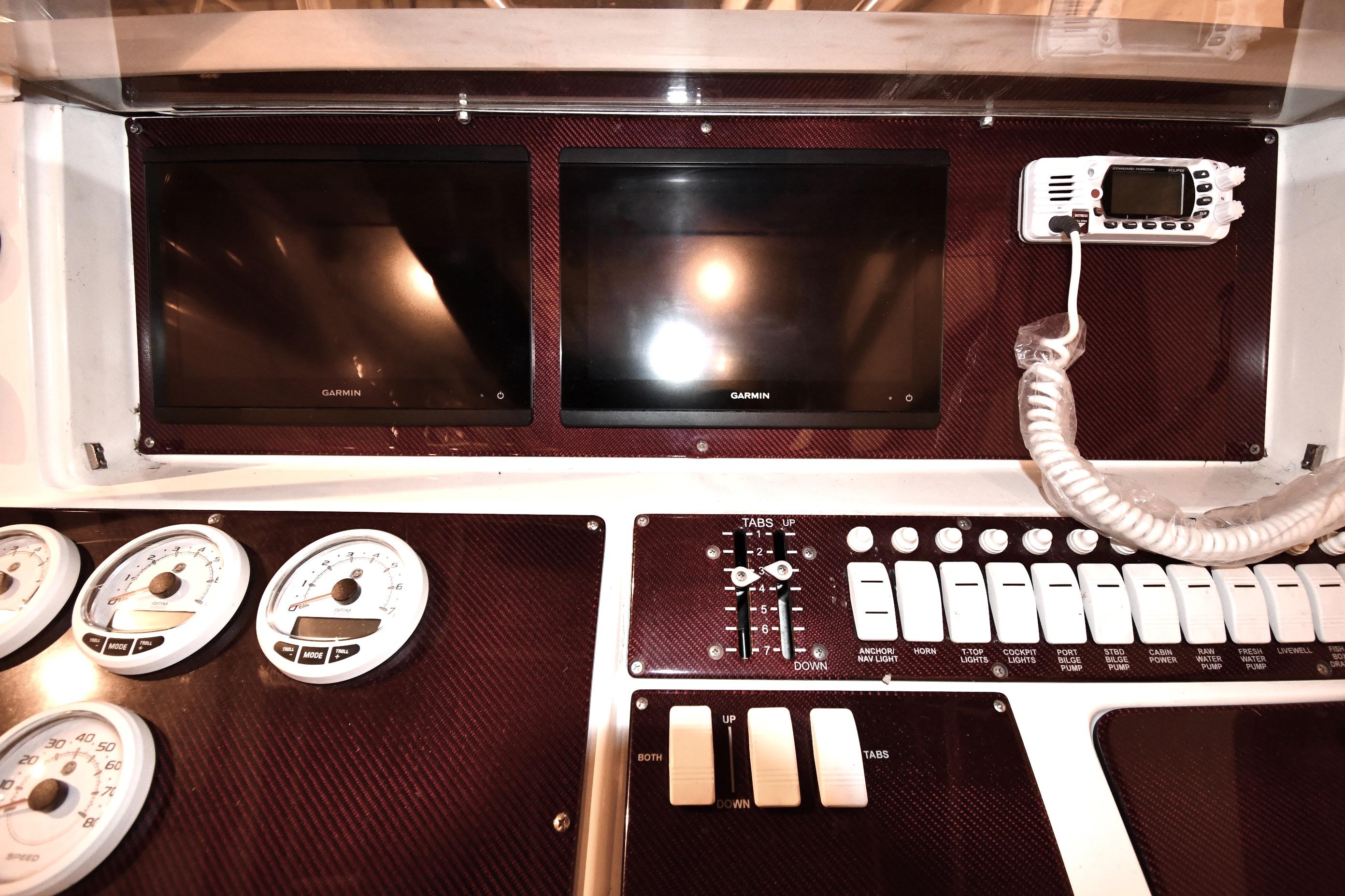 2001 Fountain 38 Center Console dashboard with Garmin displays and control switches.