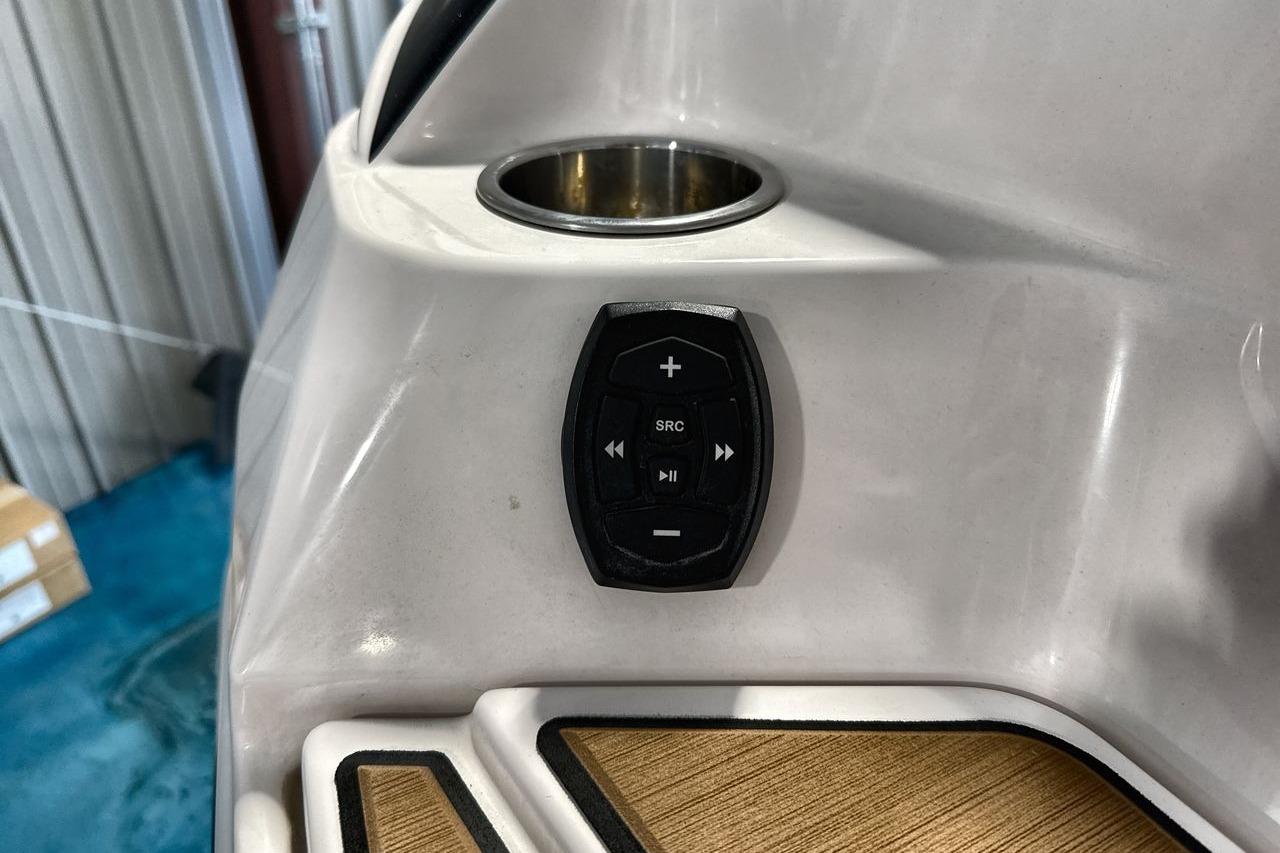 2020 Supra SE boat audio control panel with cup holder and teak flooring.