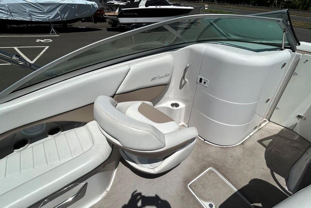 2006 Four Winns 244 Funship boat interior with white seating and cup holders.