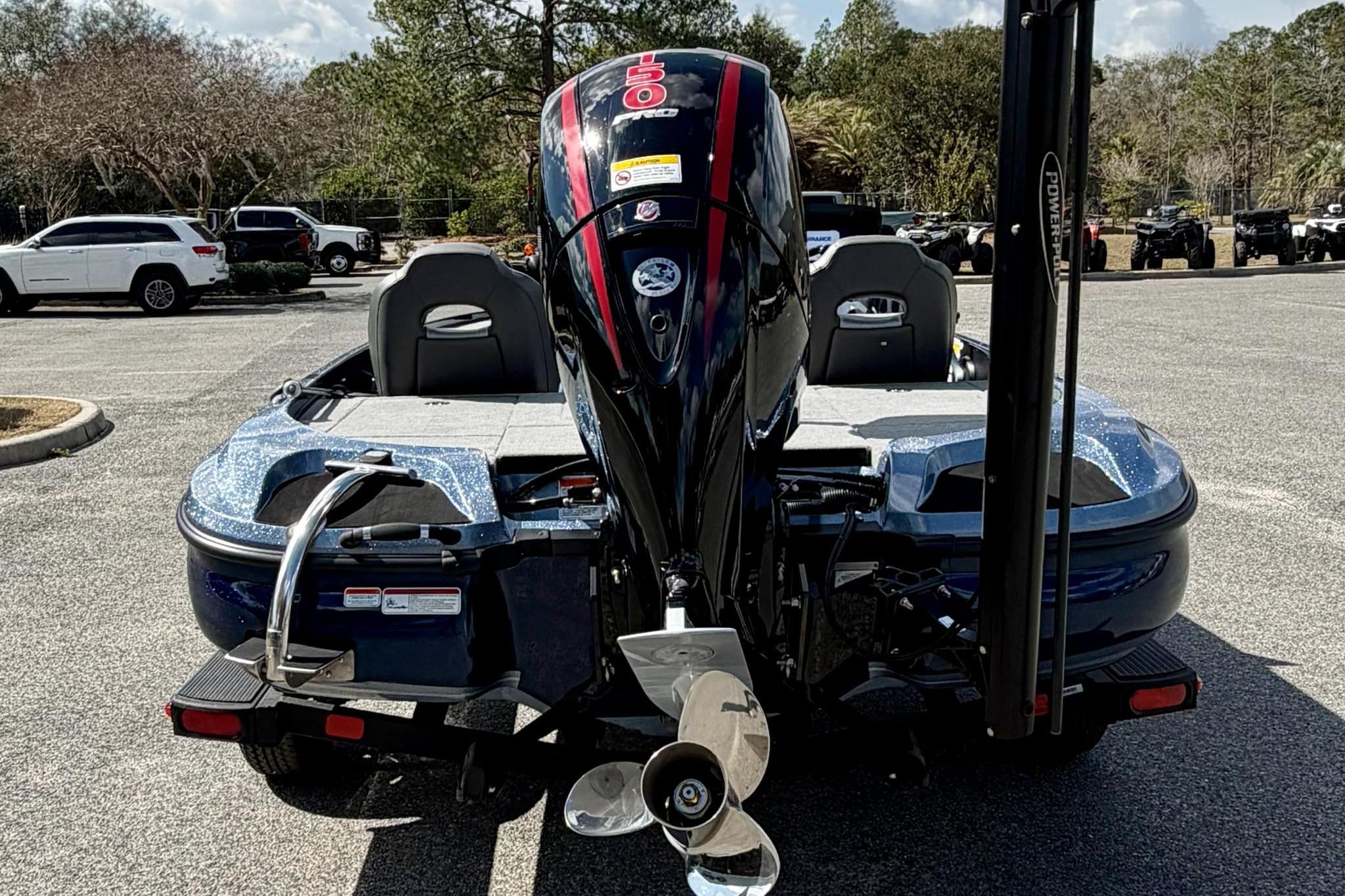 2026 Nitro Z18 boat with powerful outboard motor, parked in a lot.