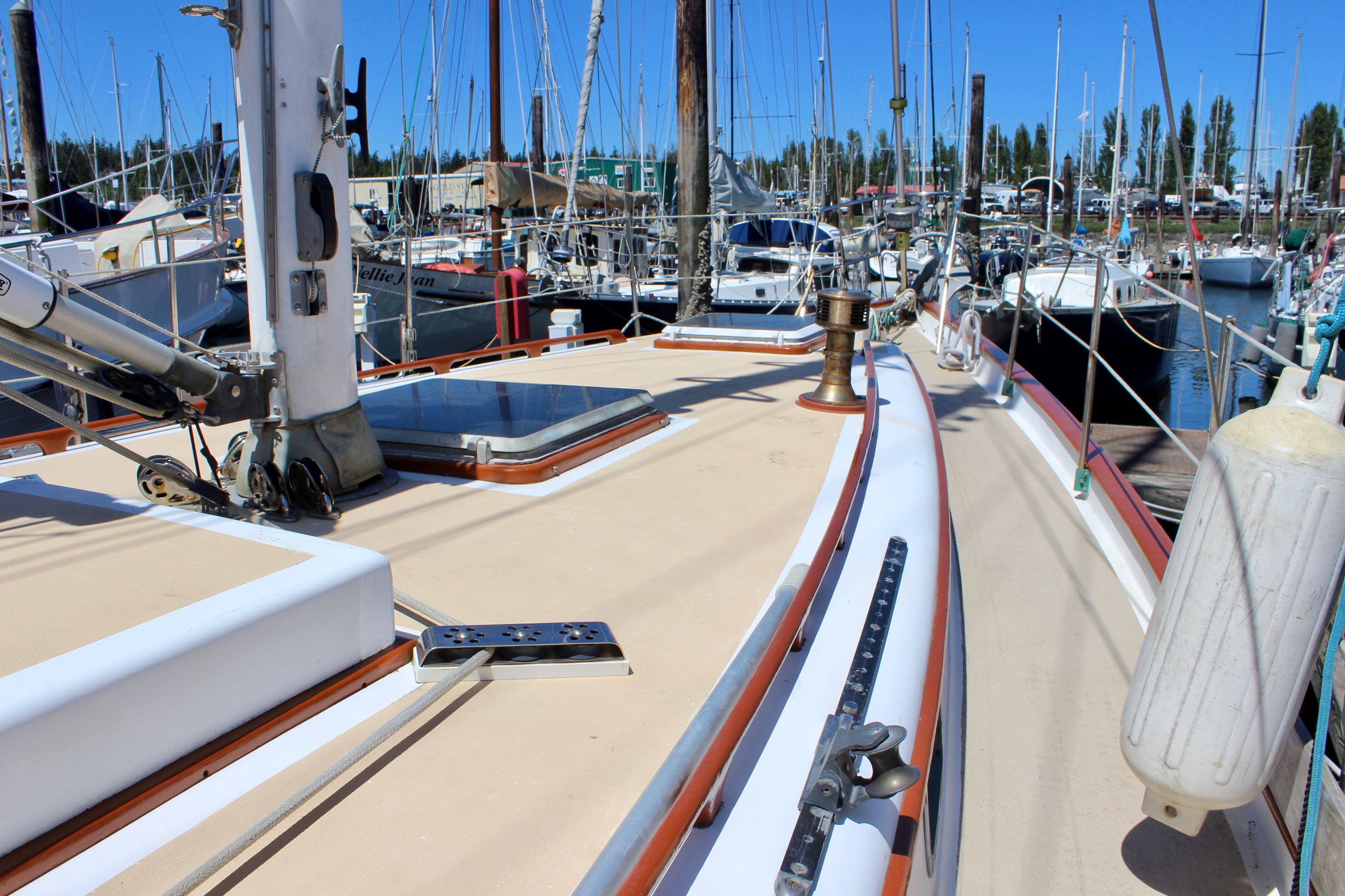 Deck view of a 1981 Kelly Peterson 46 sailboat docked in a marina.