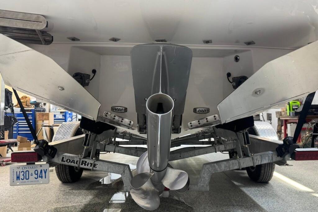 Rear view of a 2022 Regal LS6 Surf boat on a trailer in a garage.