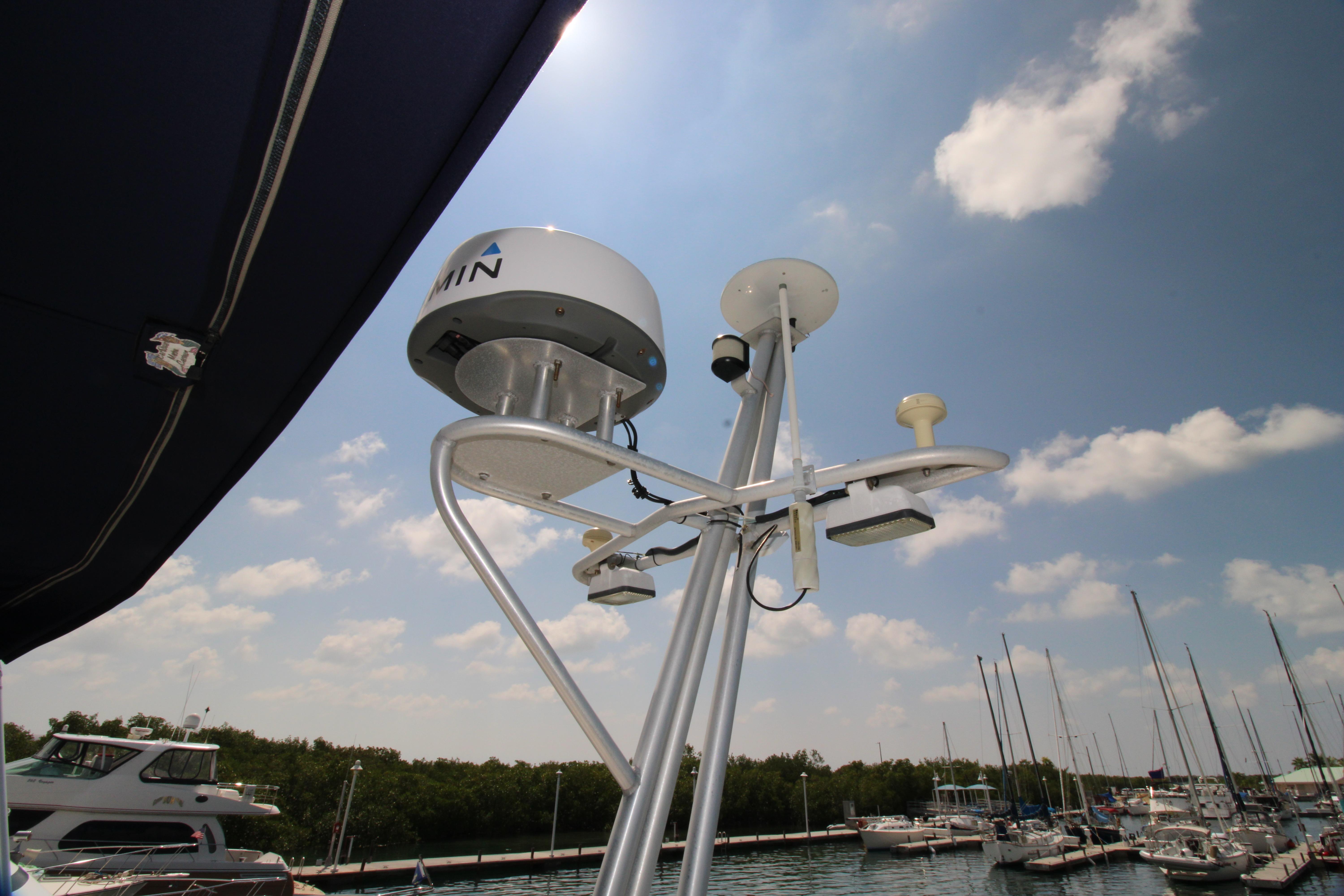 Radar and antenna equipment on a 2000 Ricker 42 Classic yacht, docked at a marina.