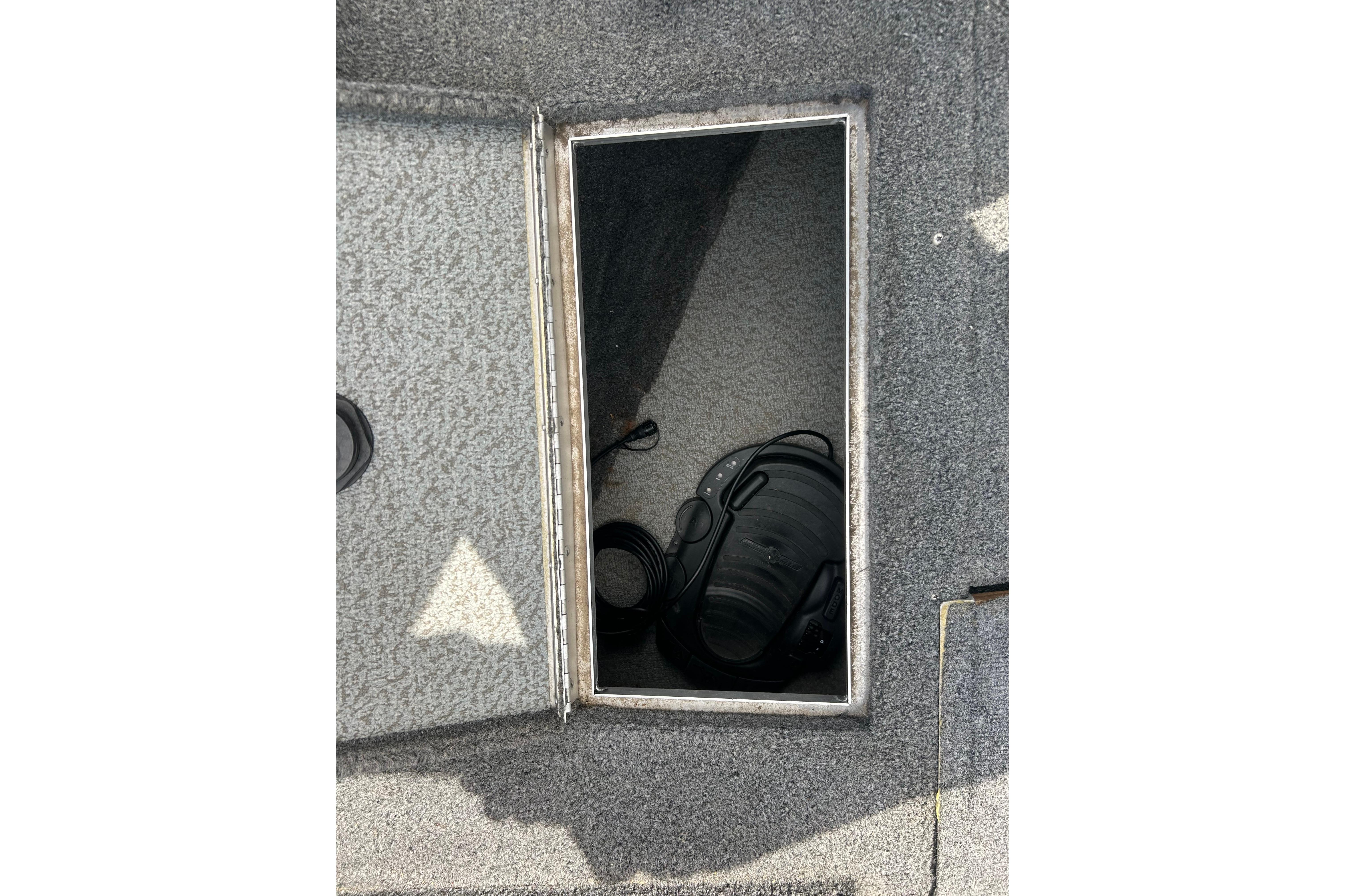 Open storage compartment on 2008 Lund 1850 Fisherman boat deck.