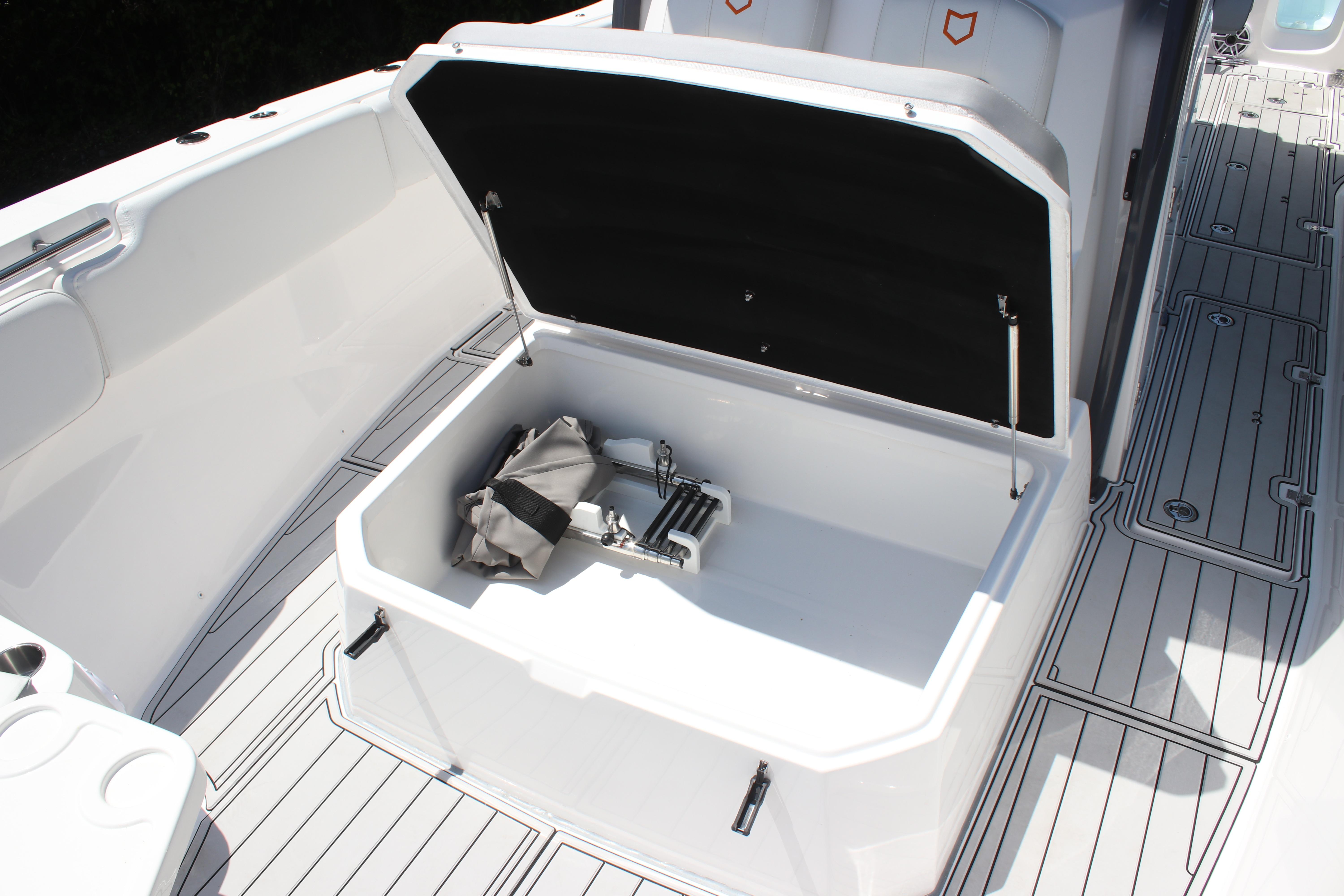 2025 Sea Fox 328 Commander boat storage compartment with open lid and accessories.