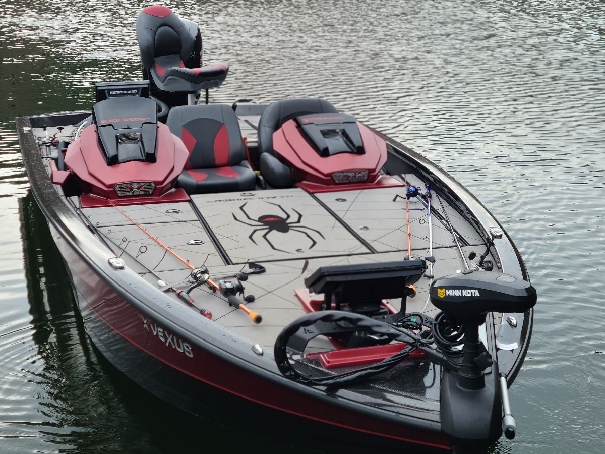 A 2021 Vexus AVX1980 BLACK WIDOW boat on calm water.
