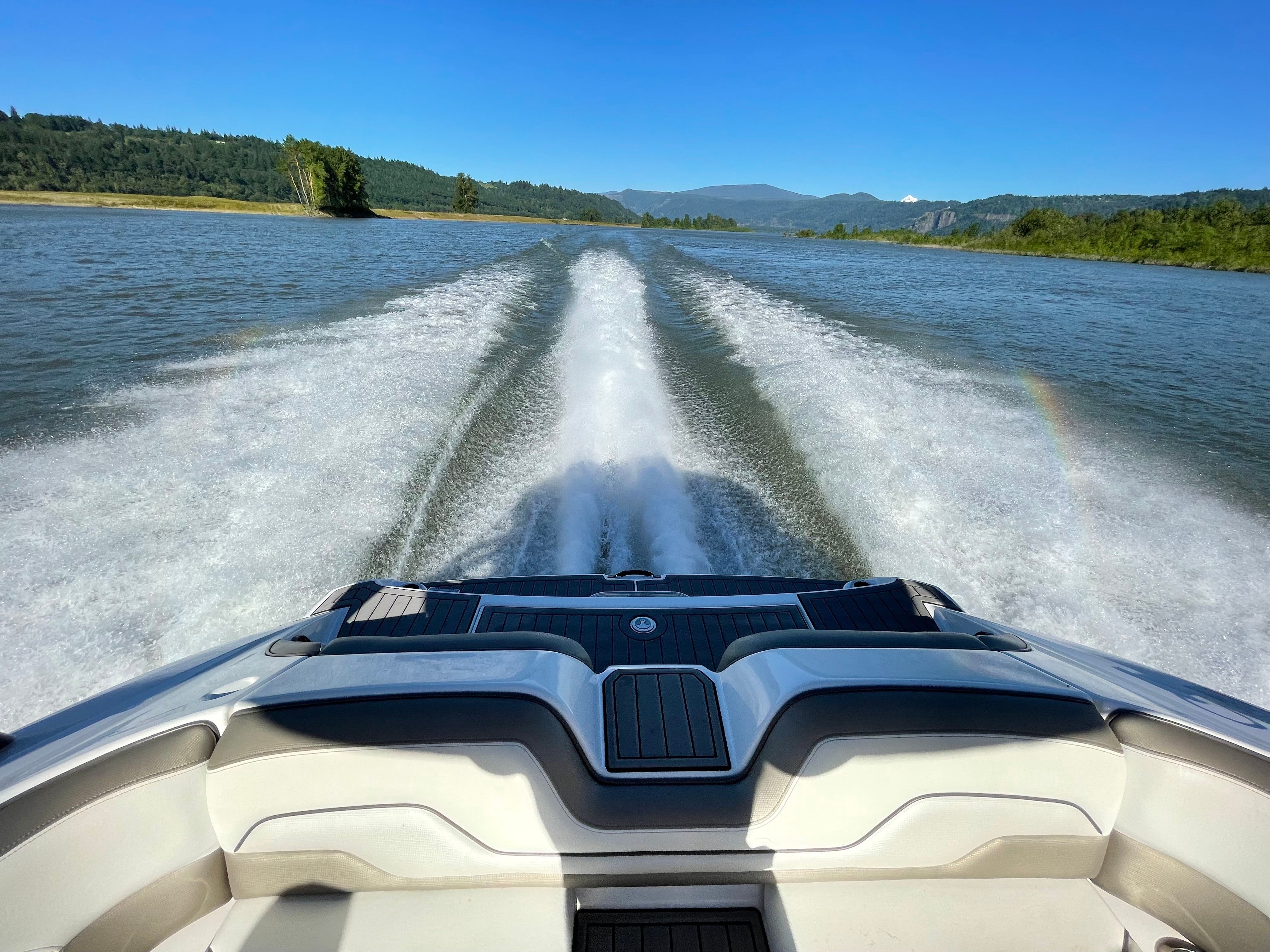 A Yamaha 212 Limited S boat speeds across the water, leaving a trail of wake.