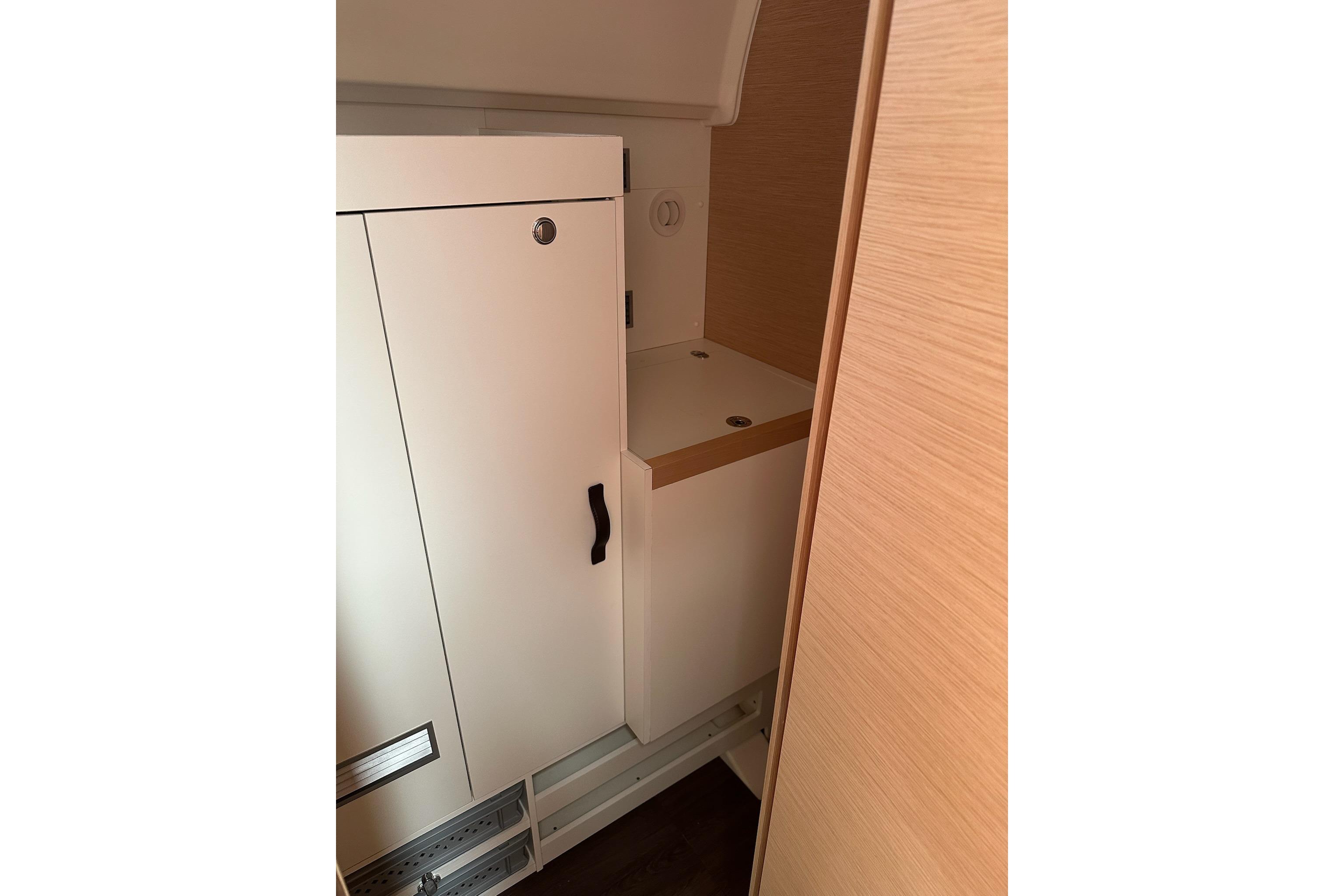 Interior storage area of a 2018 Jeanneau 51 yacht, featuring sleek cabinetry.
