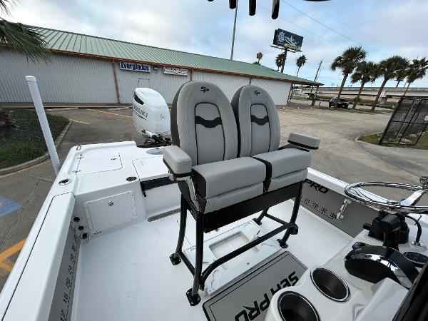 2024 Sea Pro 250 DLX boat interior with dual seats and steering console.