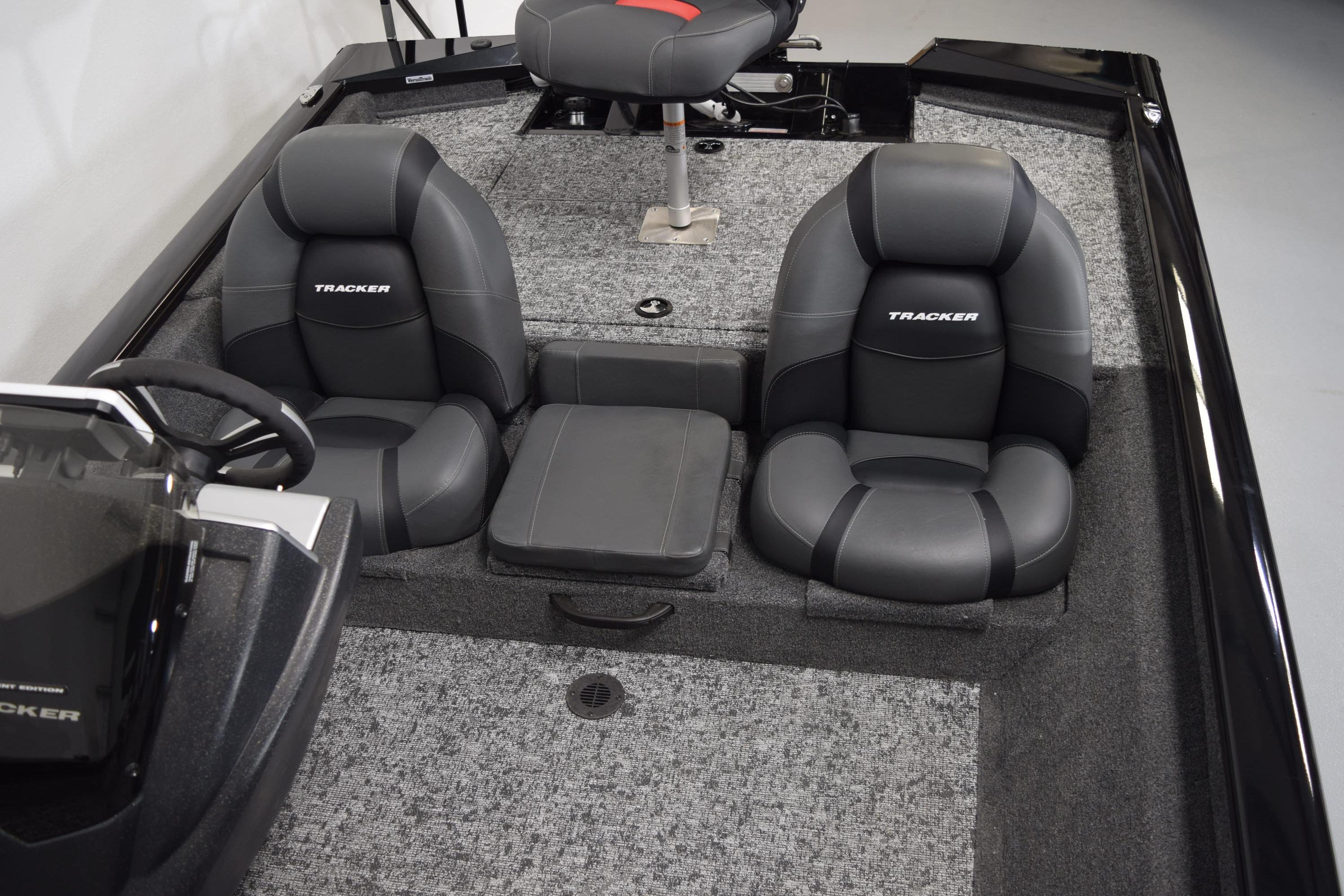 2026 Tracker Pro Team 175 boat interior with cushioned seating and steering console.