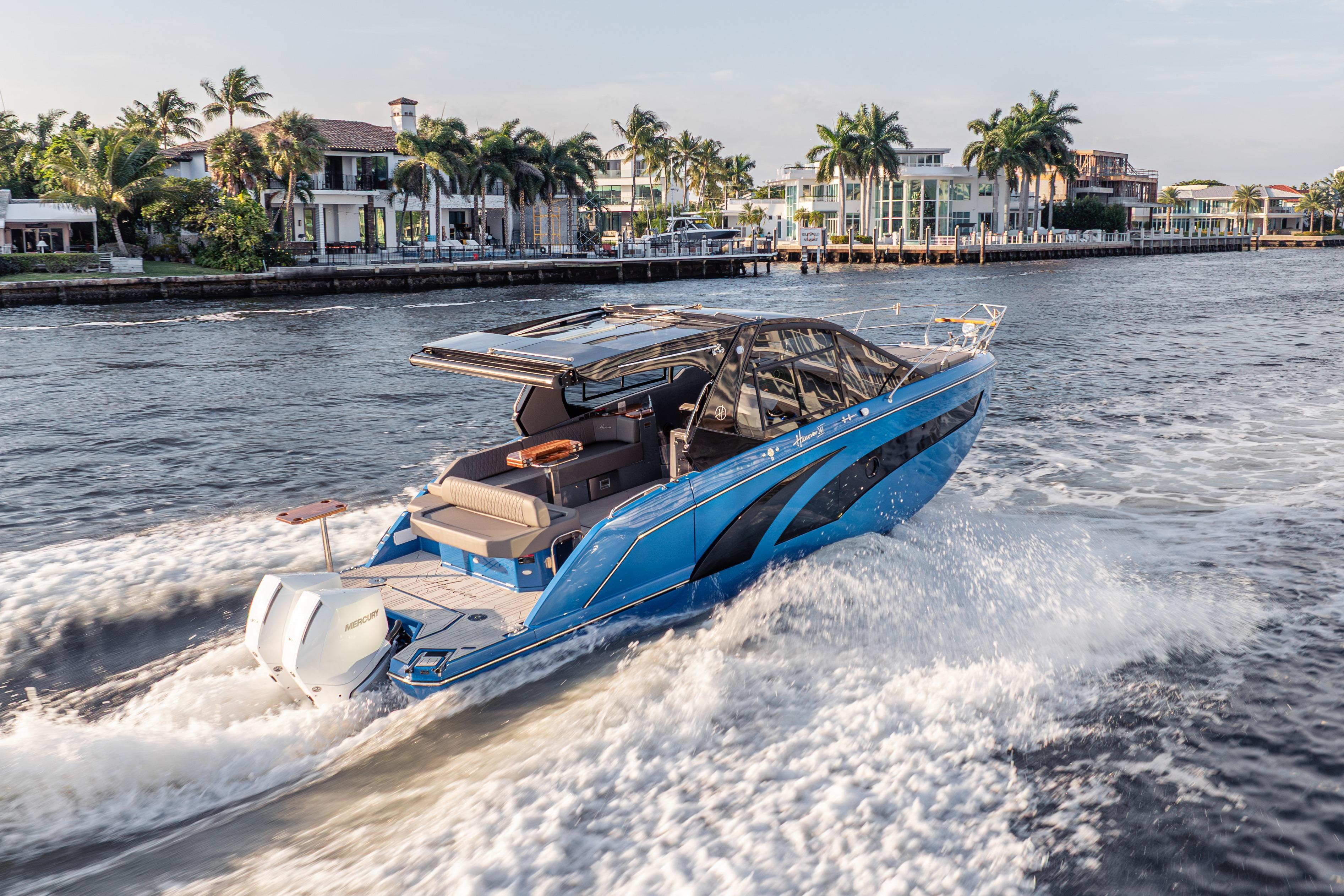 Luxury Hanover 347 boat cruising near waterfront homes, 2026 model.