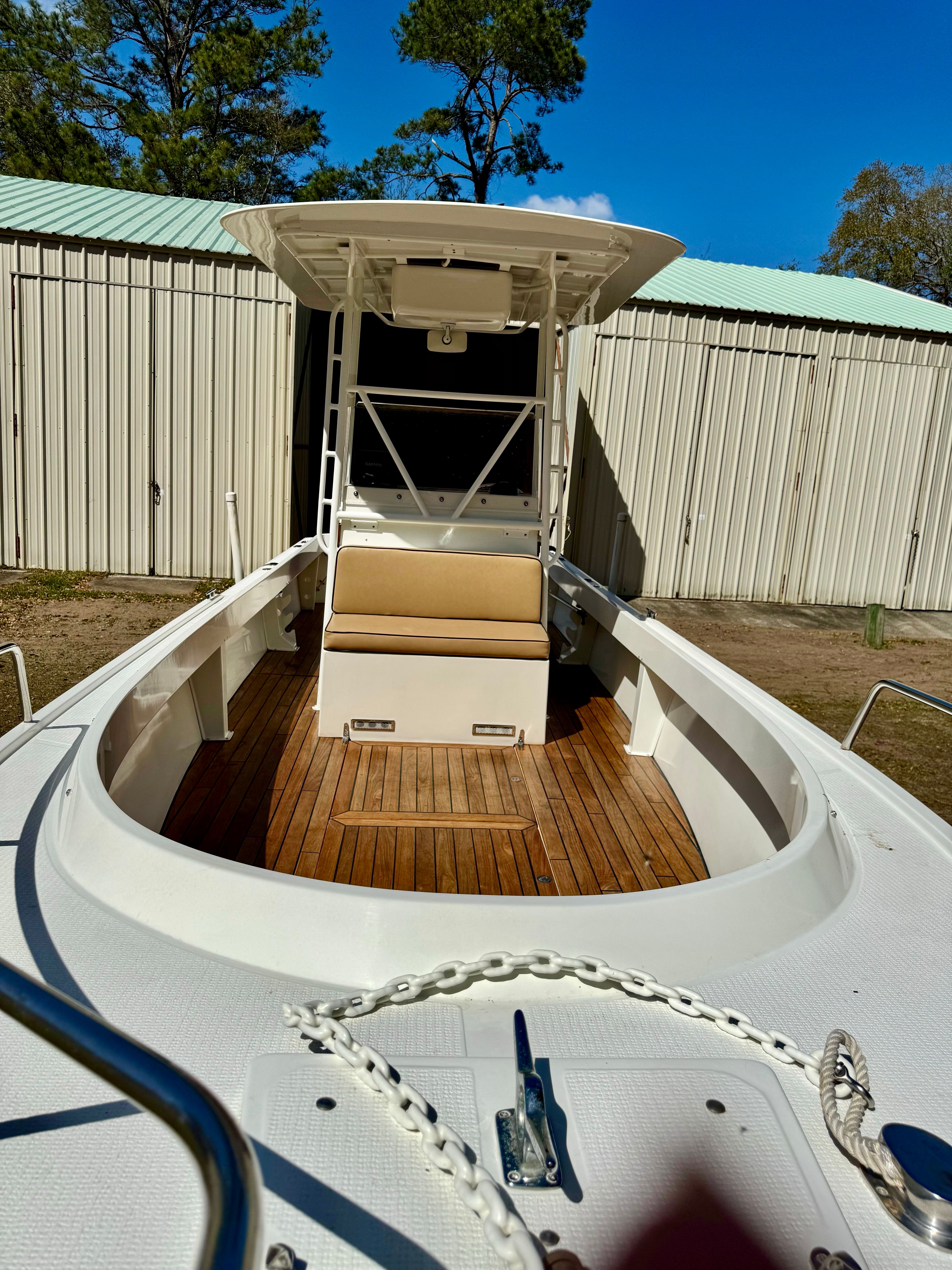1990 Shamrock 26-foot open CC boat with wooden deck.