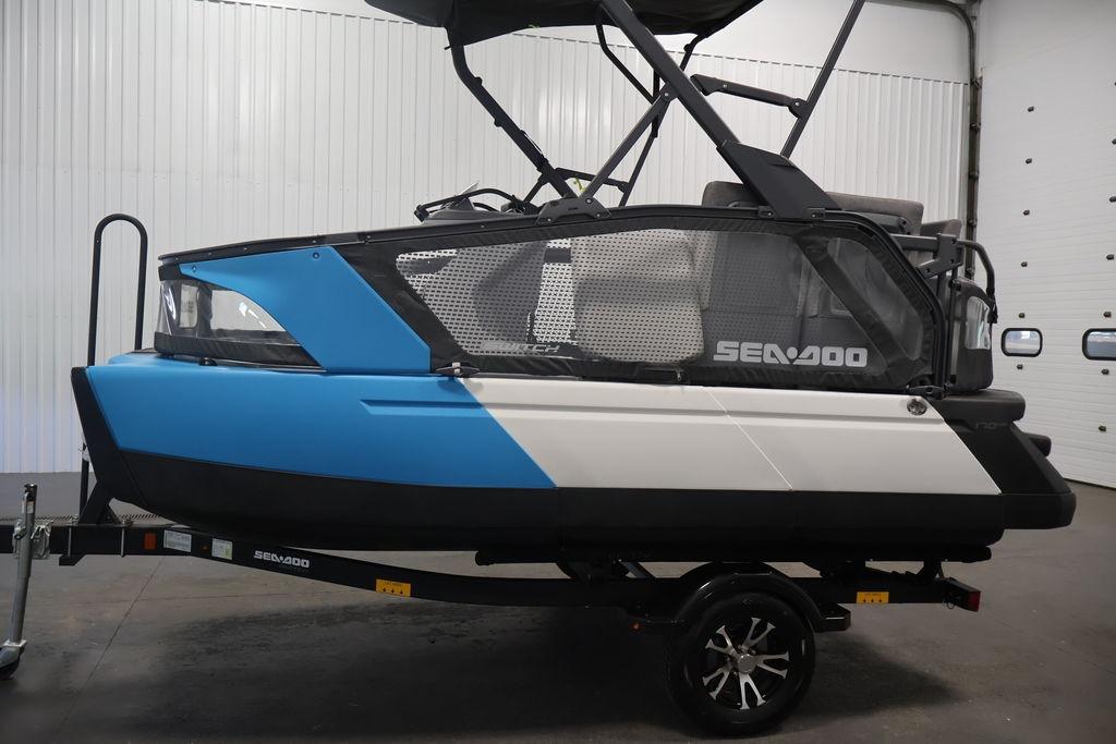 2023 Sea-Doo Switch Sport Compact in a showroom, featuring sleek blue and white design.