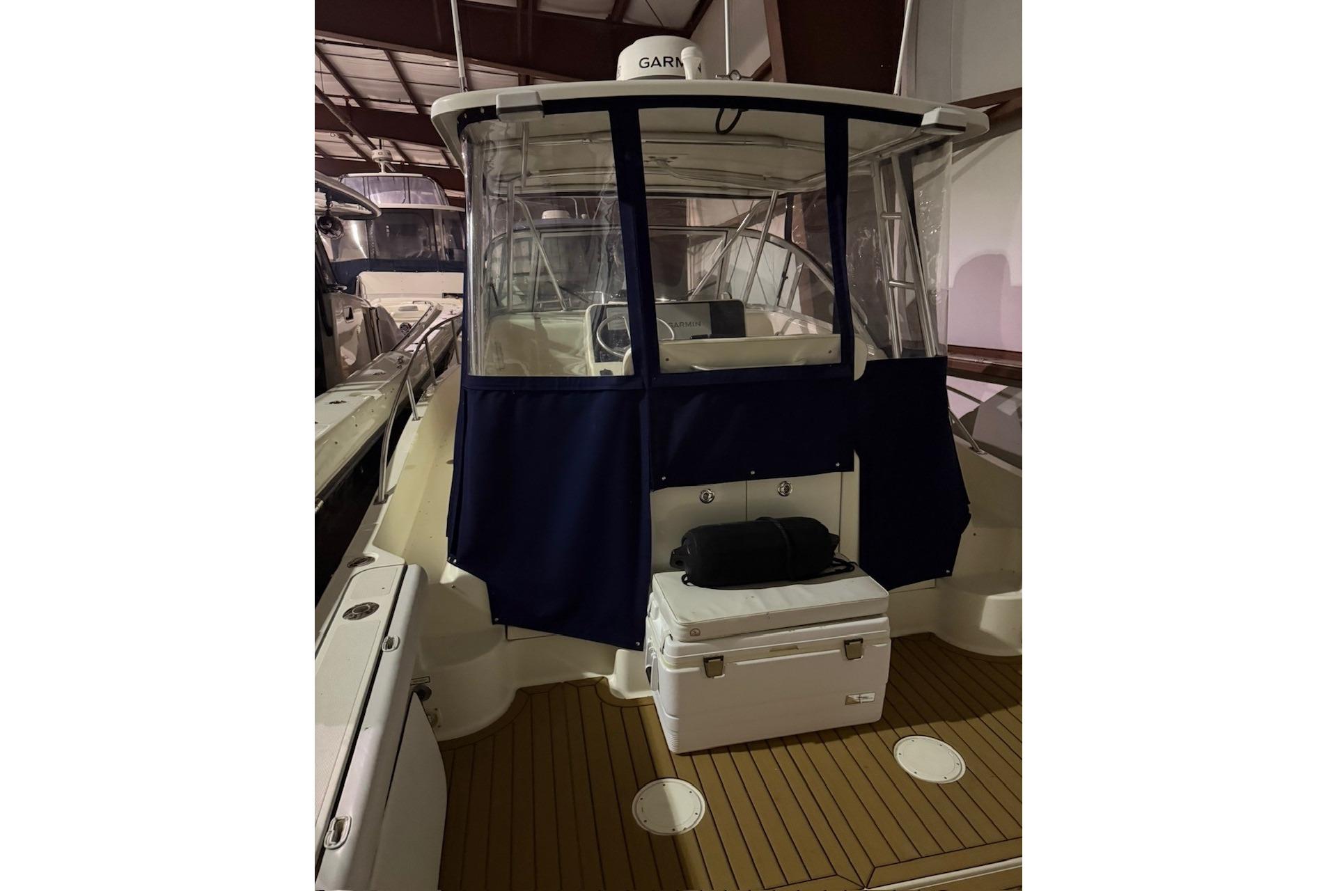 2000 Pursuit 3070 Offshore Center Console boat with enclosed cockpit in storage.