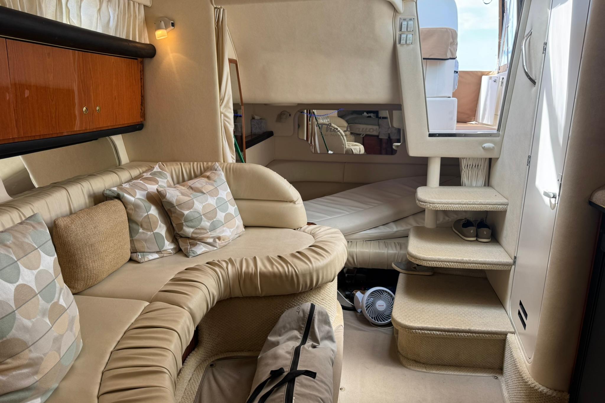 Interior of 2001 Sea Ray 340 Sundancer yacht with cozy seating and elegant decor.