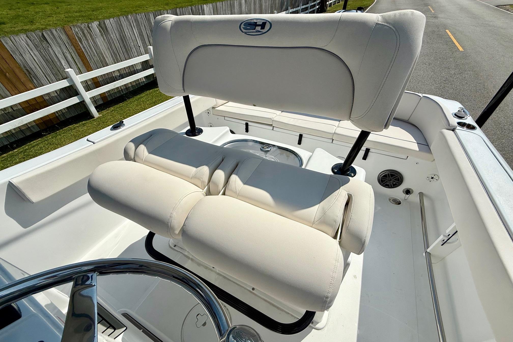 2026 Sea Hunt Ultra 229 boat interior with cushioned seating and steering wheel.