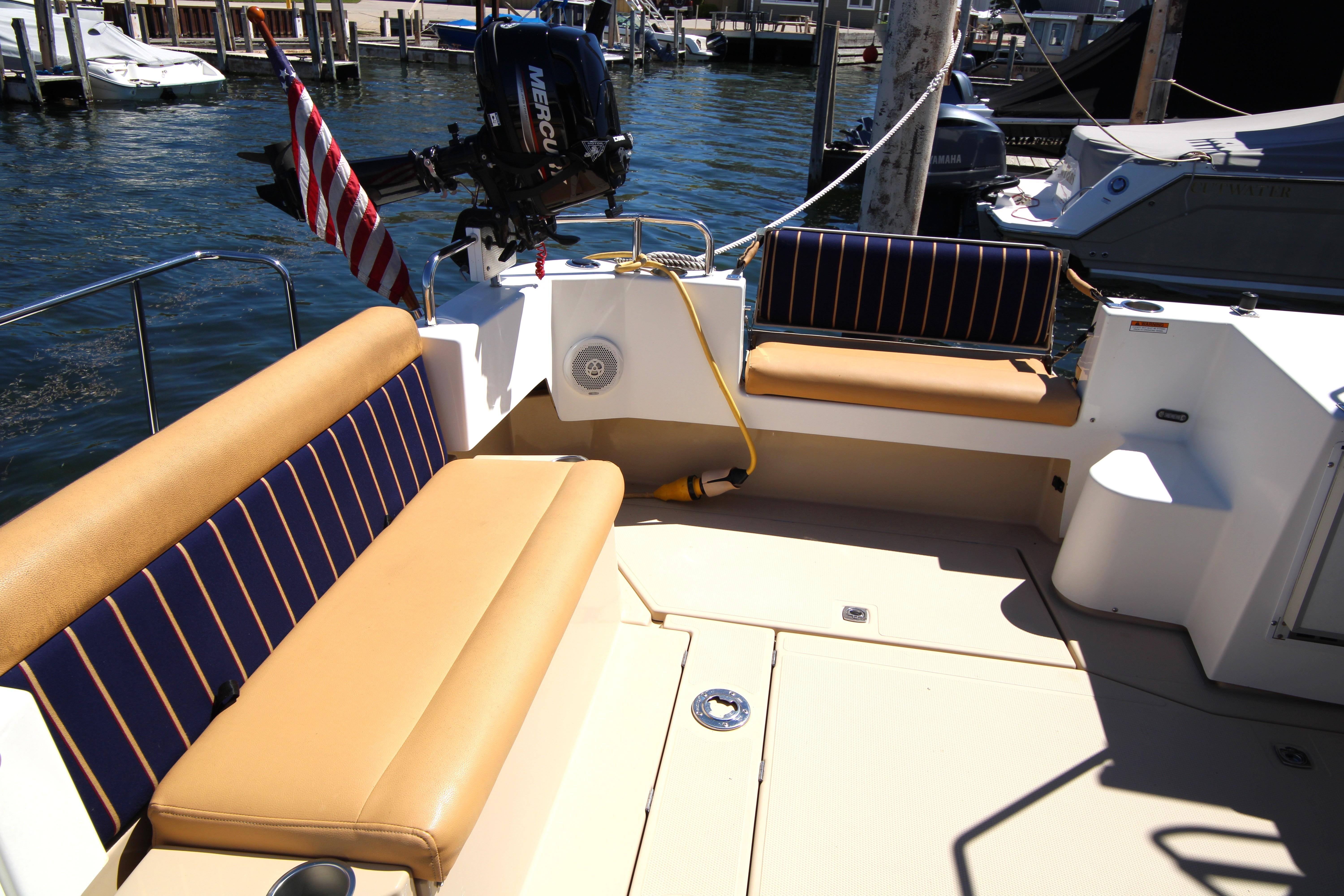 2013 Ranger Tugs R-31 CB boat deck with seating and motor, docked at marina.