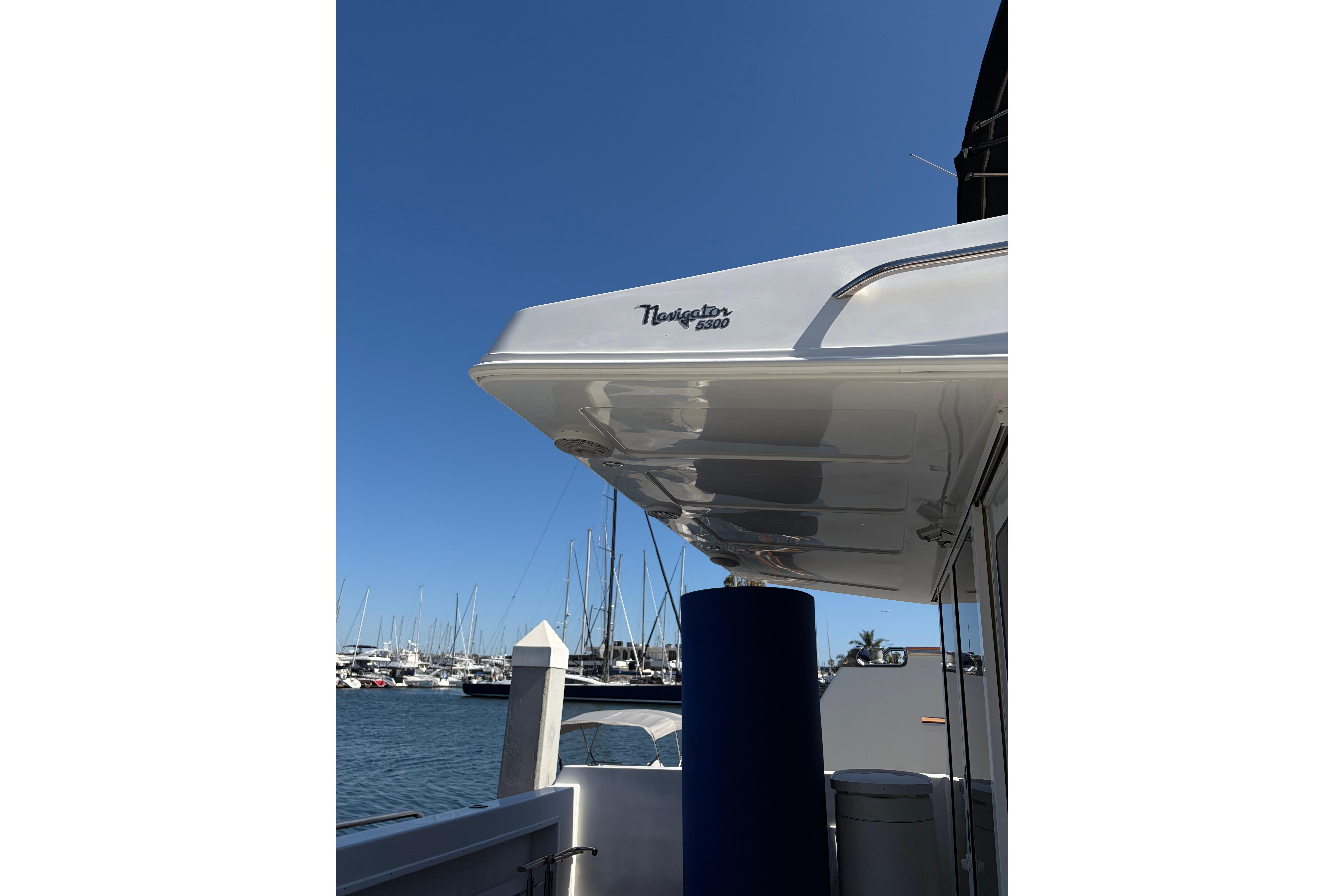 2005 Navigator 53 Pilot House yacht docked at marina under clear blue sky.