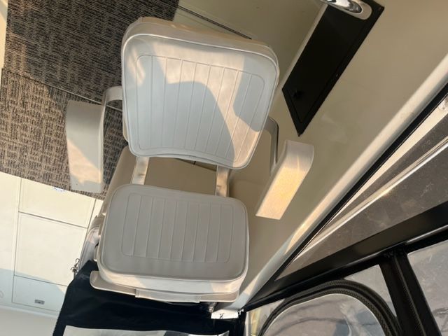 Interior of a 2002 Carolina Classic 25 boat with white seats.