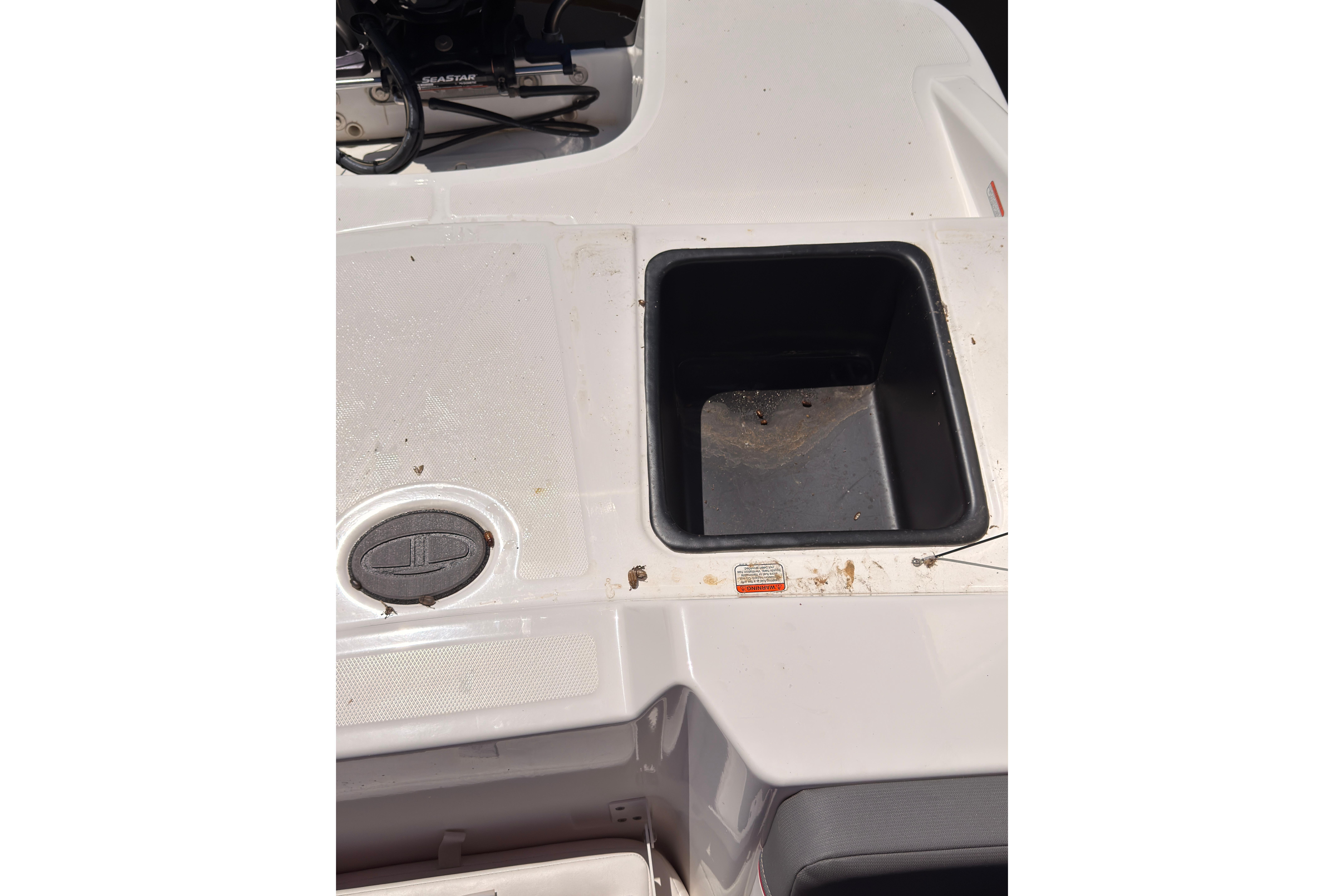 2022 Tahoe T18 boat deck with storage compartment and control panel.