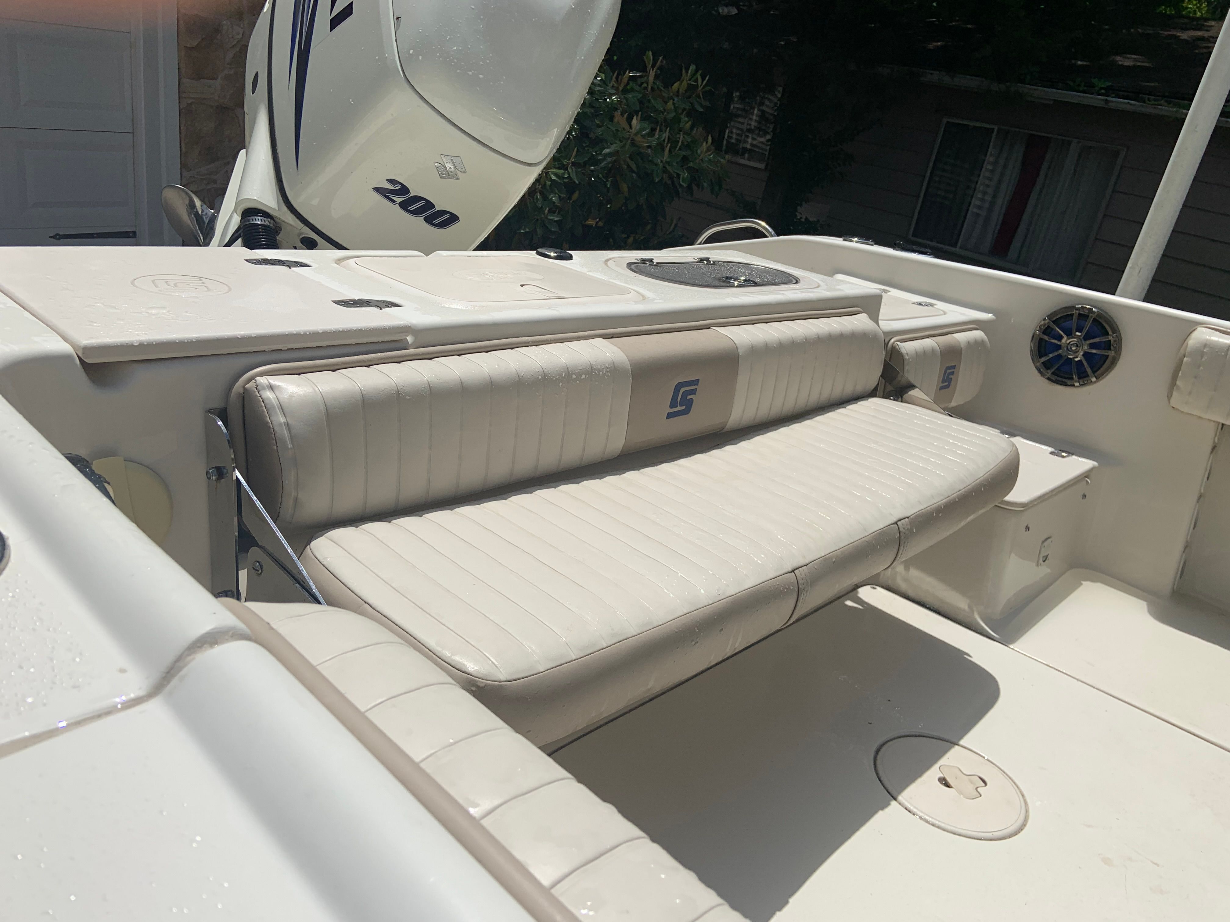 2014 Carolina Skiff 23 Ultra Elite boat with bench seating and motor.