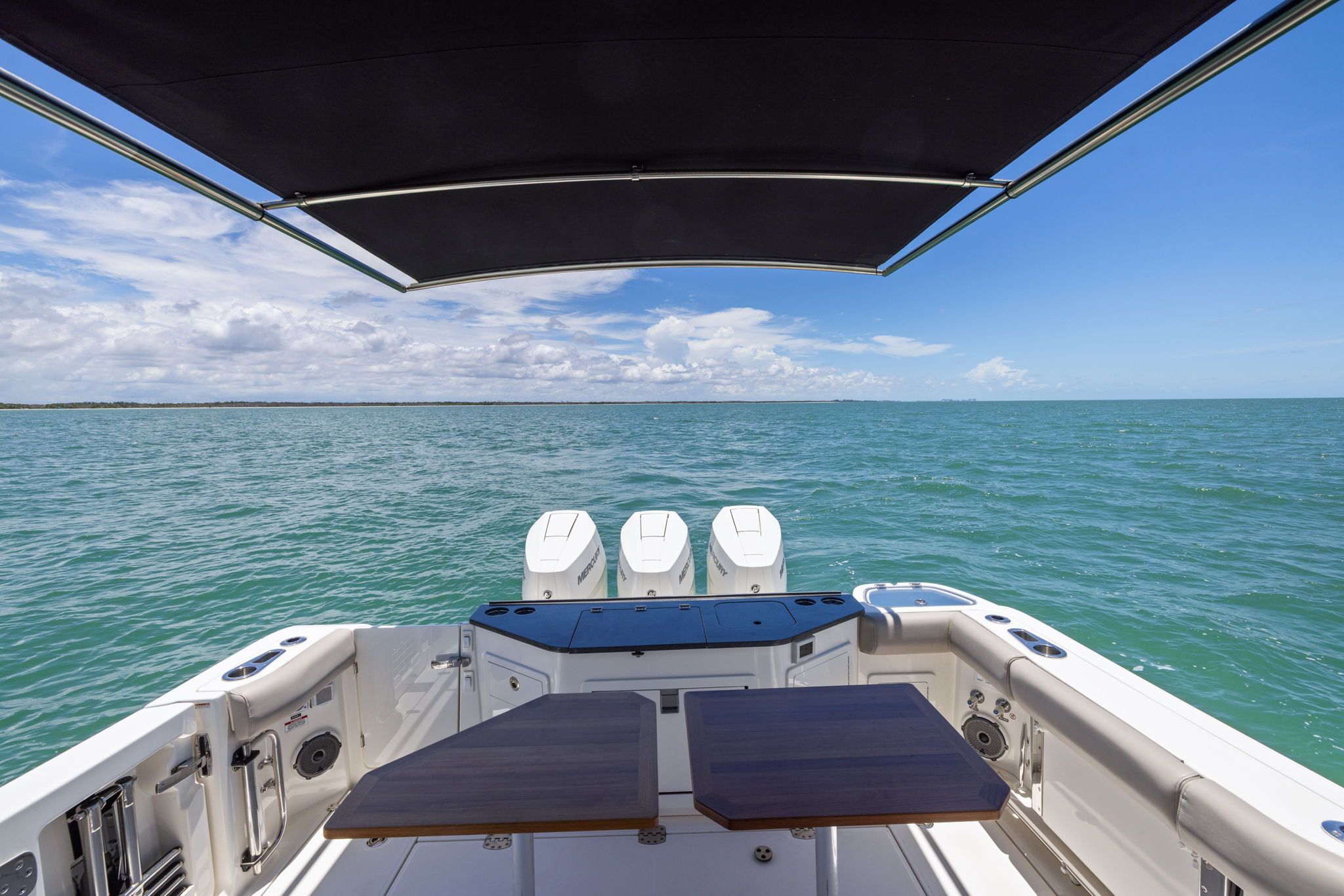 Boston Whaler 365 Conquest 2025 on open sea with sunshade.
