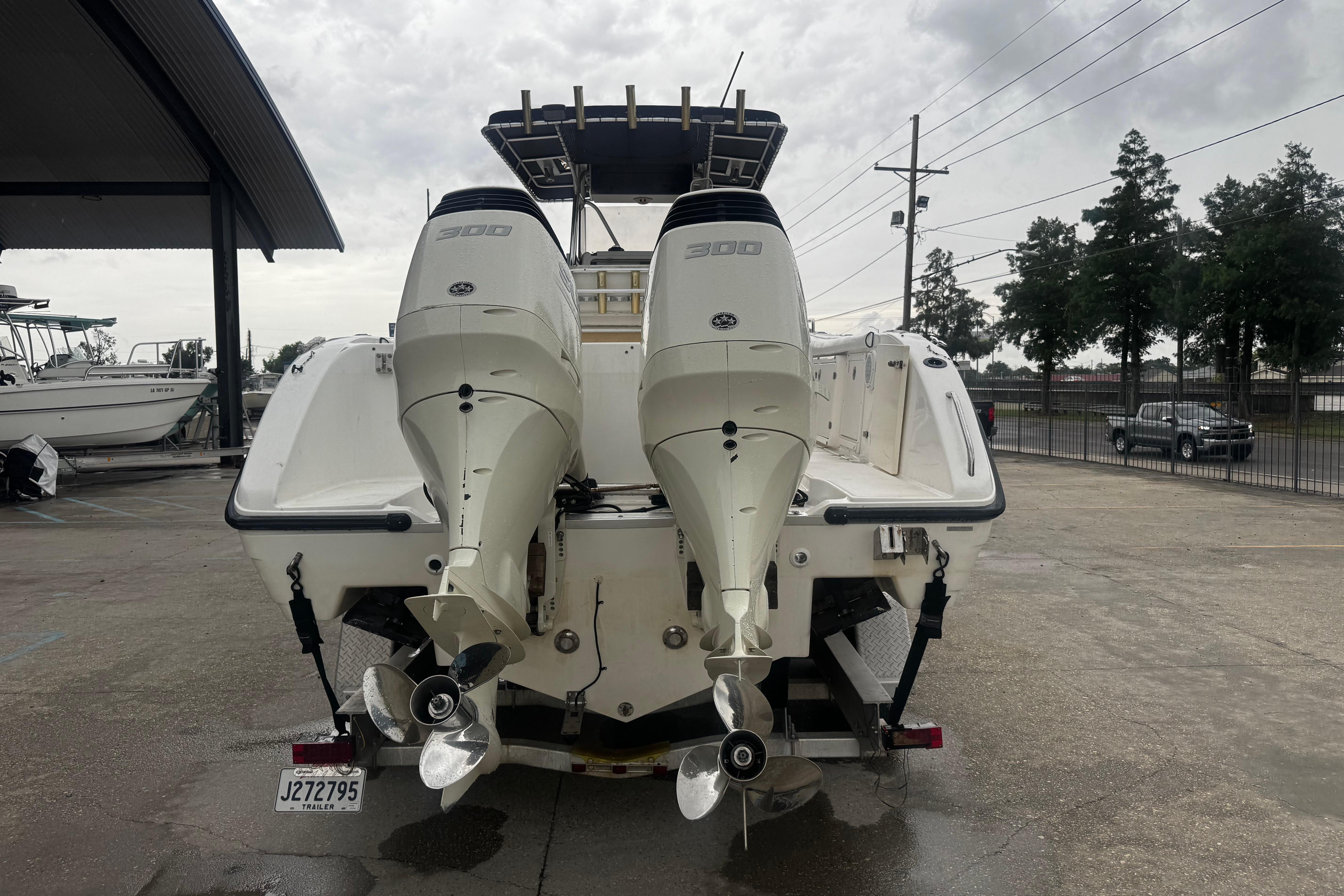 2004 Century 2900 Center Console boat with dual outboard engines on a trailer.