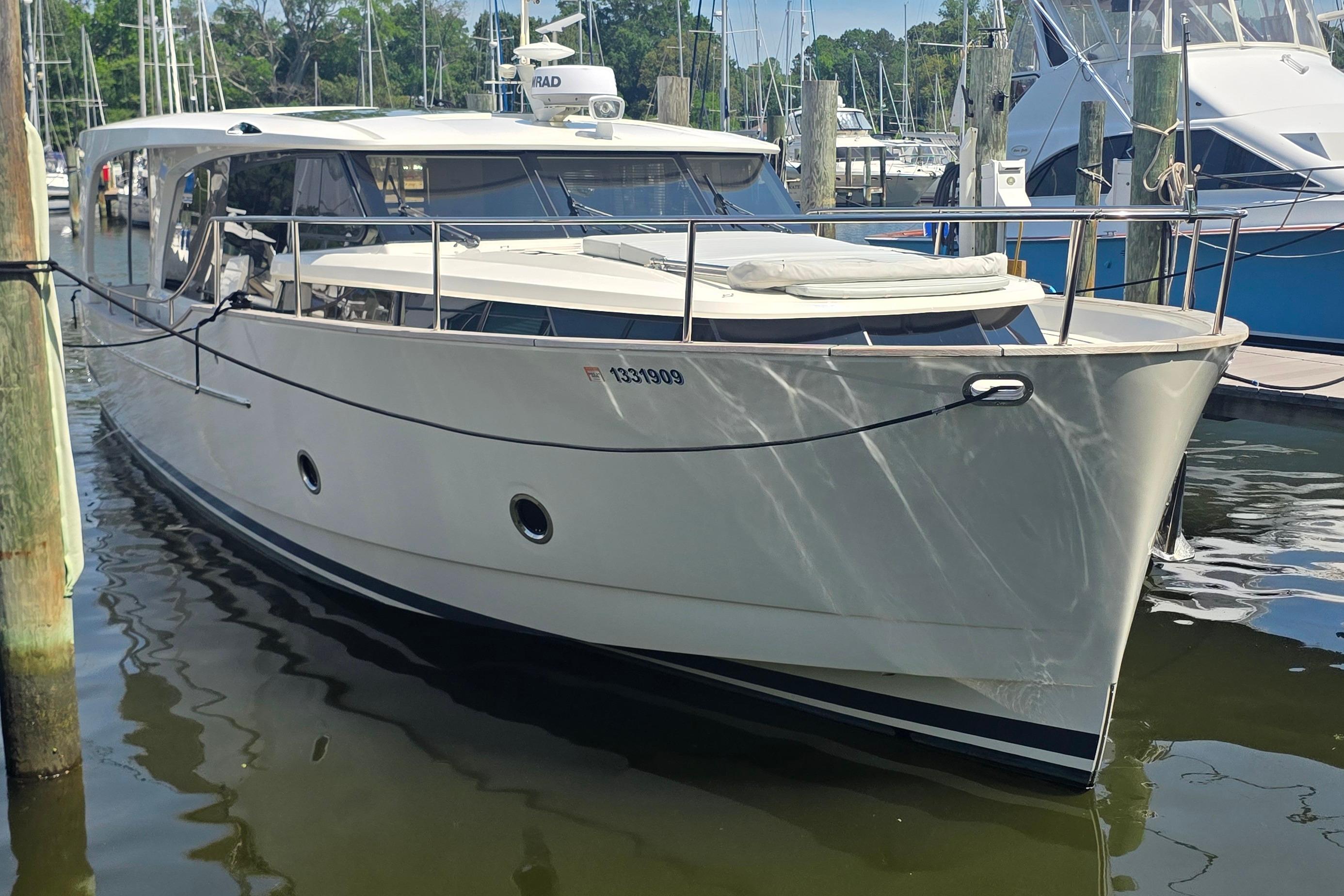 2023 Greenline 40 yacht docked at marina, showcasing sleek design and modern features.