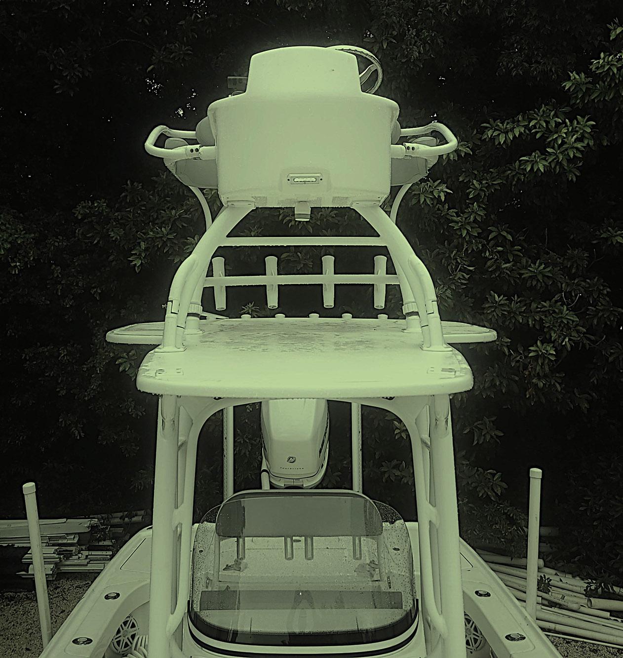 2017 SeaVee 270Z boat with elevated helm station, surrounded by lush greenery.