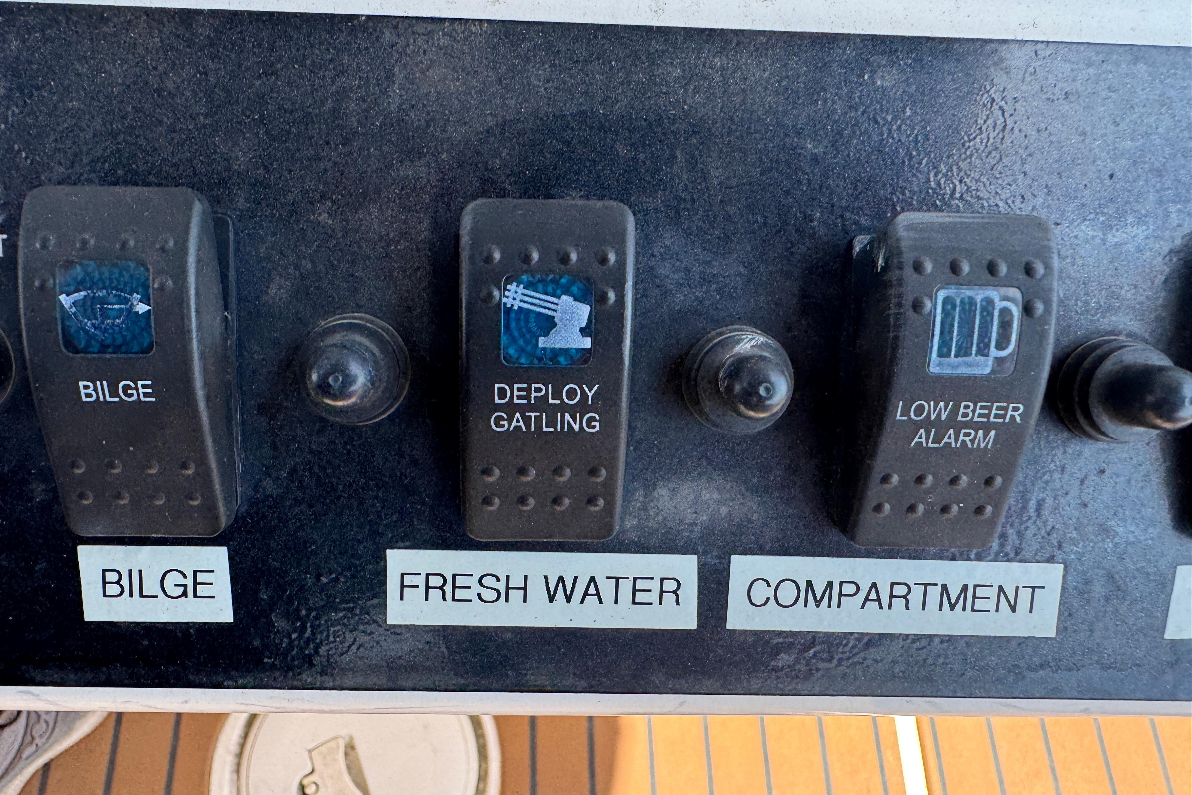 Control panel of a 2014 Century 2301 Center Console boat with humorous switch labels.