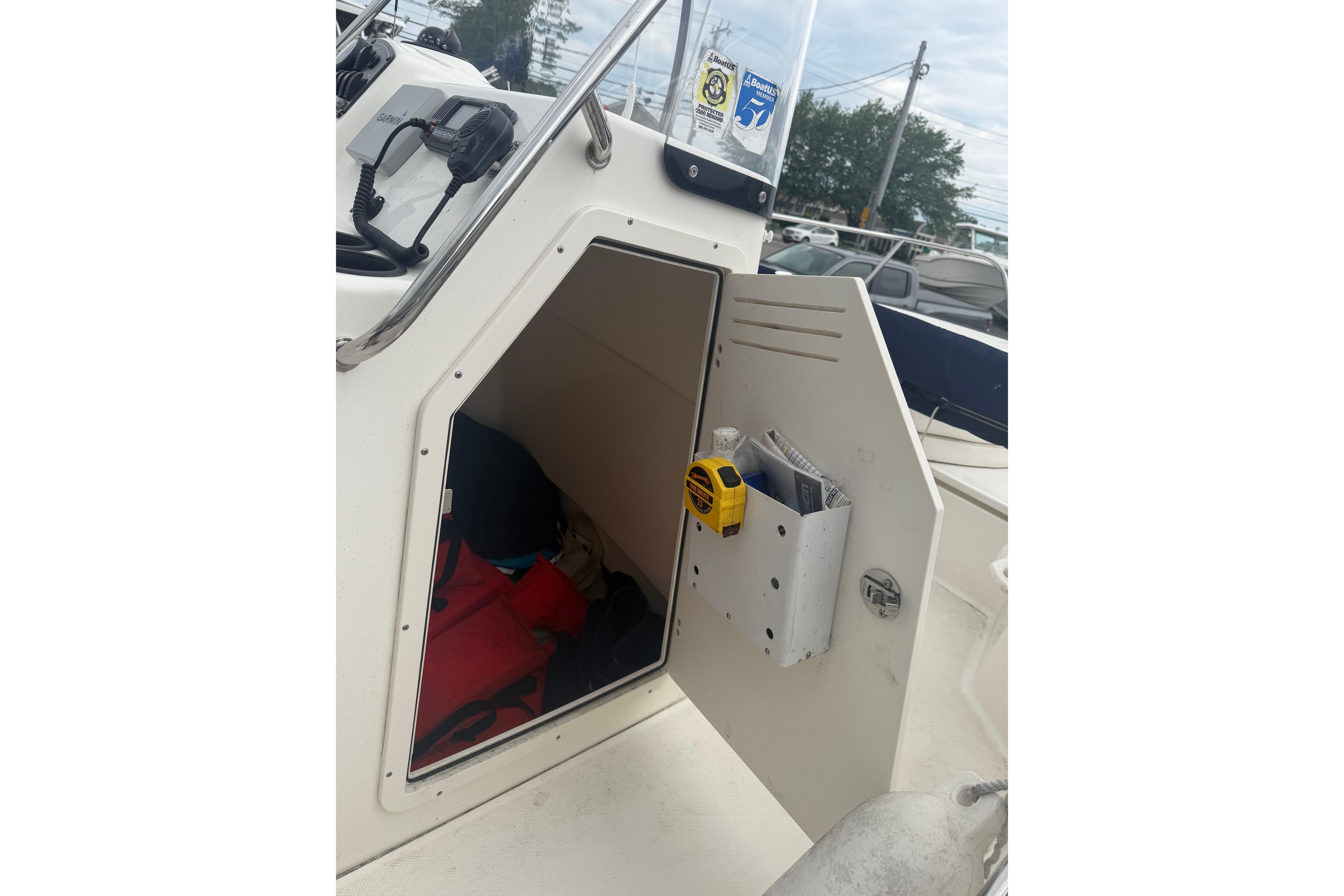 2015 Boston Whaler 210 Montauk storage compartment with safety gear and equipment.