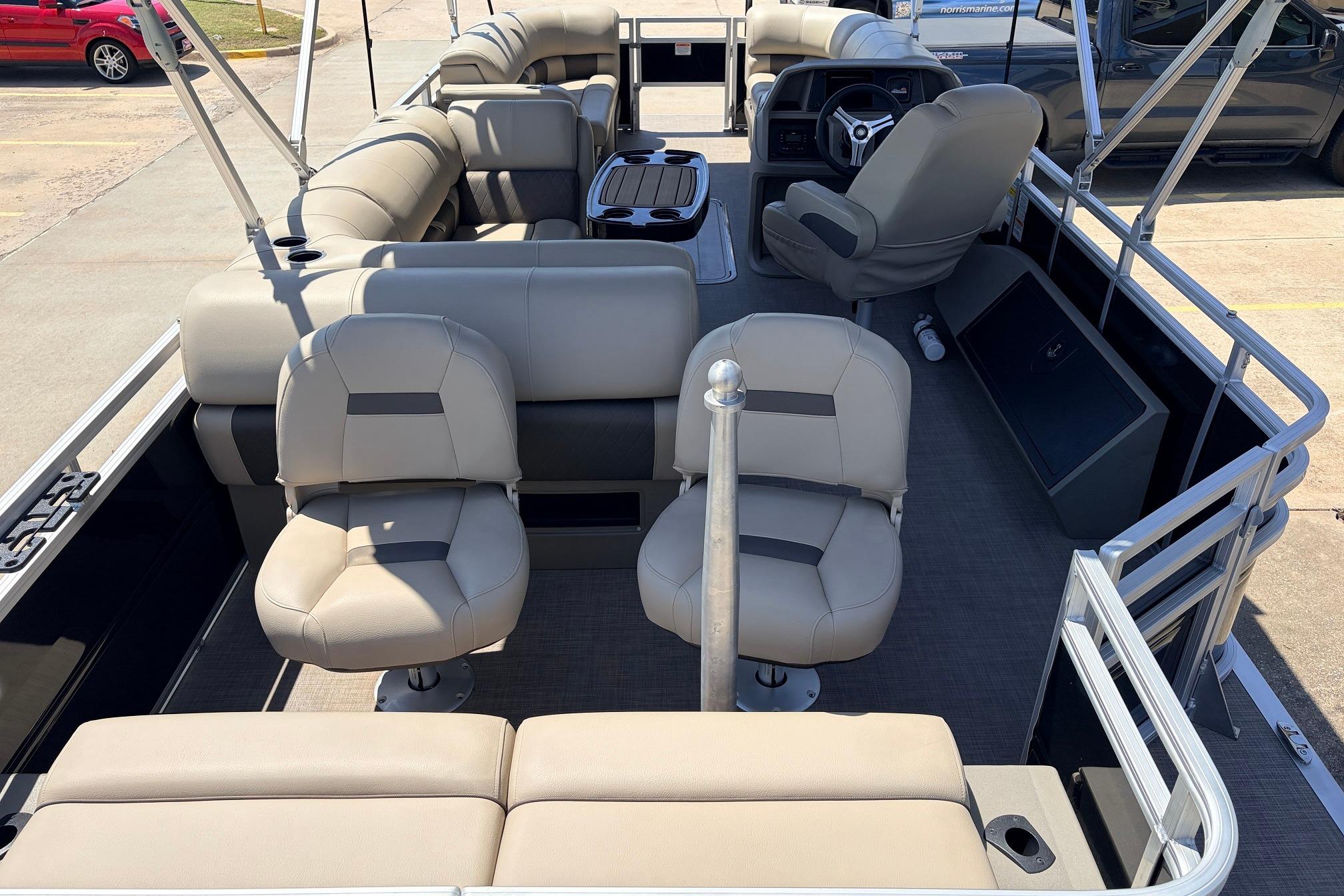 2024 Sun Tracker SportFish 22 XP3 pontoon boat interior with beige seating and steering console.