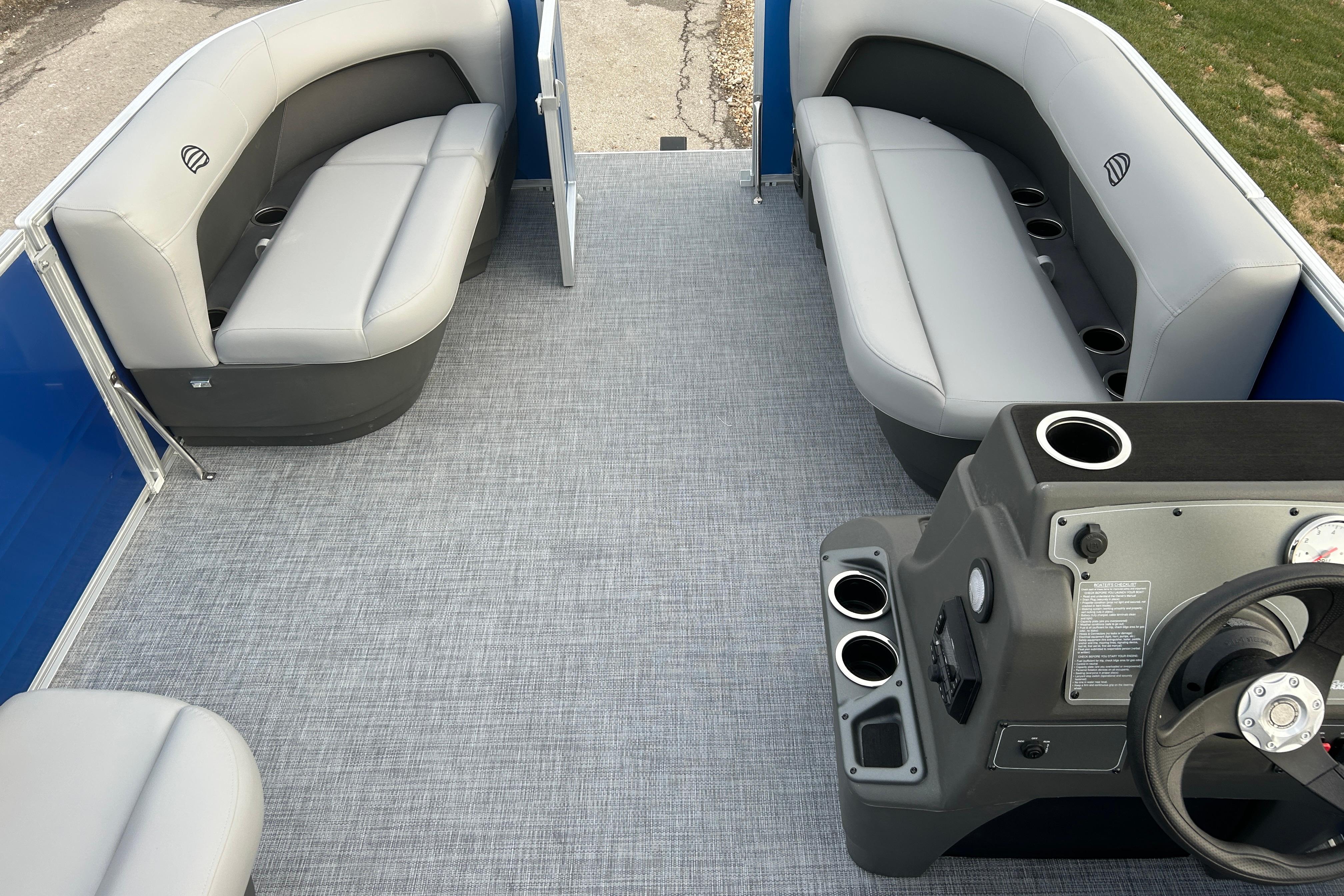 Interior of 2026 Sun Tracker Party Barge 16 DLX with gray seating and steering console.