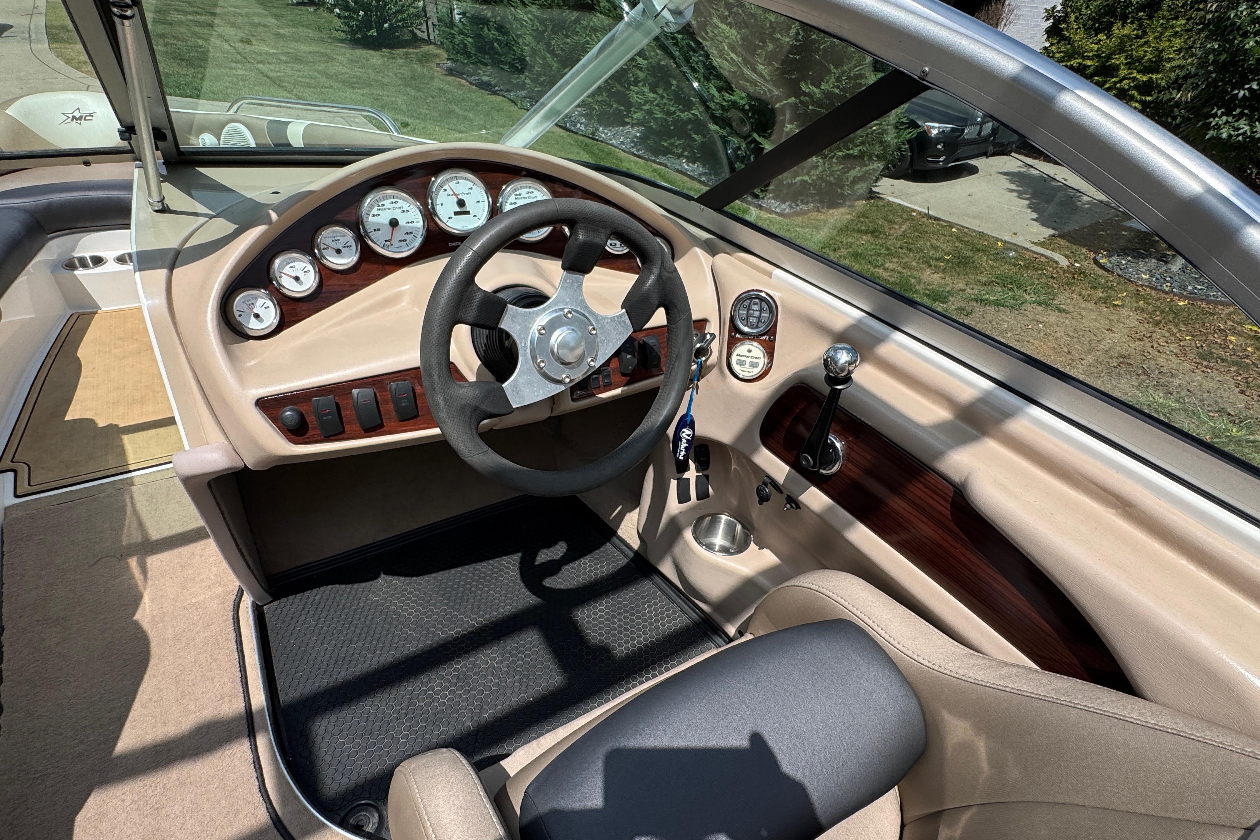 2002 MasterCraft ProStar 209 boat interior with steering wheel and dashboard controls.