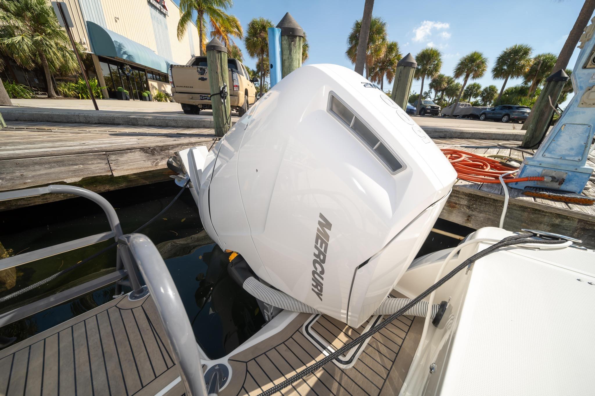 Outboard motor on a 2022 World Cat 400 CC-X boat docked at a marina.